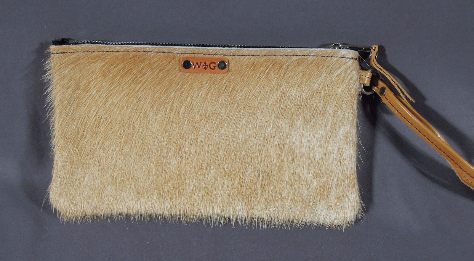 HAND CRAFTED COW HIDE WRISTLET: Brand new & excellent quality. 5 1/2" high, 10" wide.