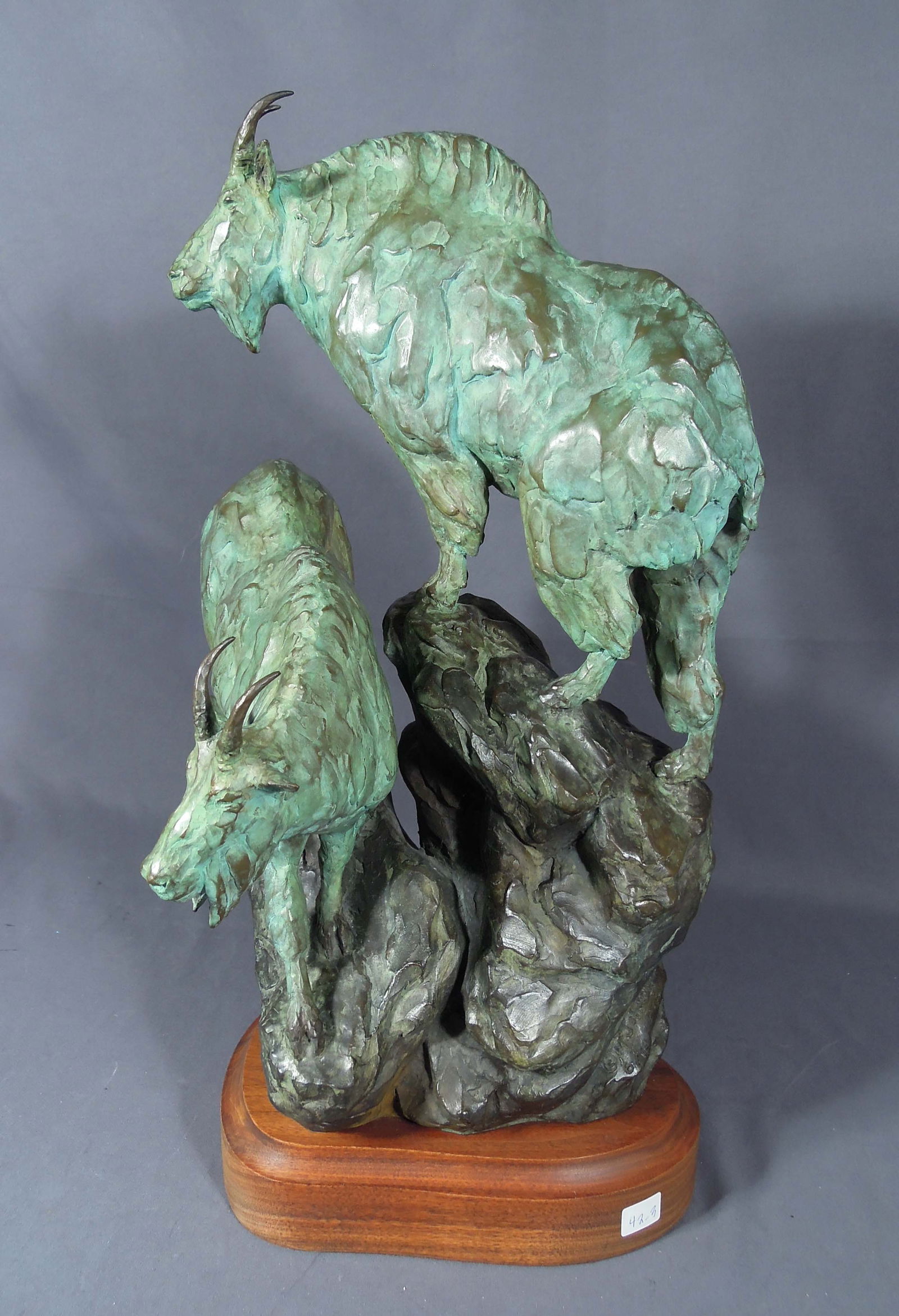 MELVIN JOHANSEN (1915-2015): Original Limited Edition bronze sculpture of mountain goats. Signed & numbered 6/10. Mounted on wooden base. 20 1/2" high, 9 1/2" wide, 10" deep.