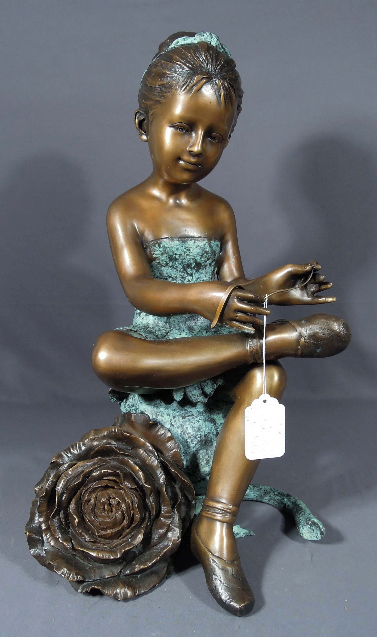 ADORABLE BRONZE SCULPTURE OF YOUNG GIRL SEATED ON ROSE: Very fine detail. Brown patina. 23 1/2 high, 13 1/2" wide.
