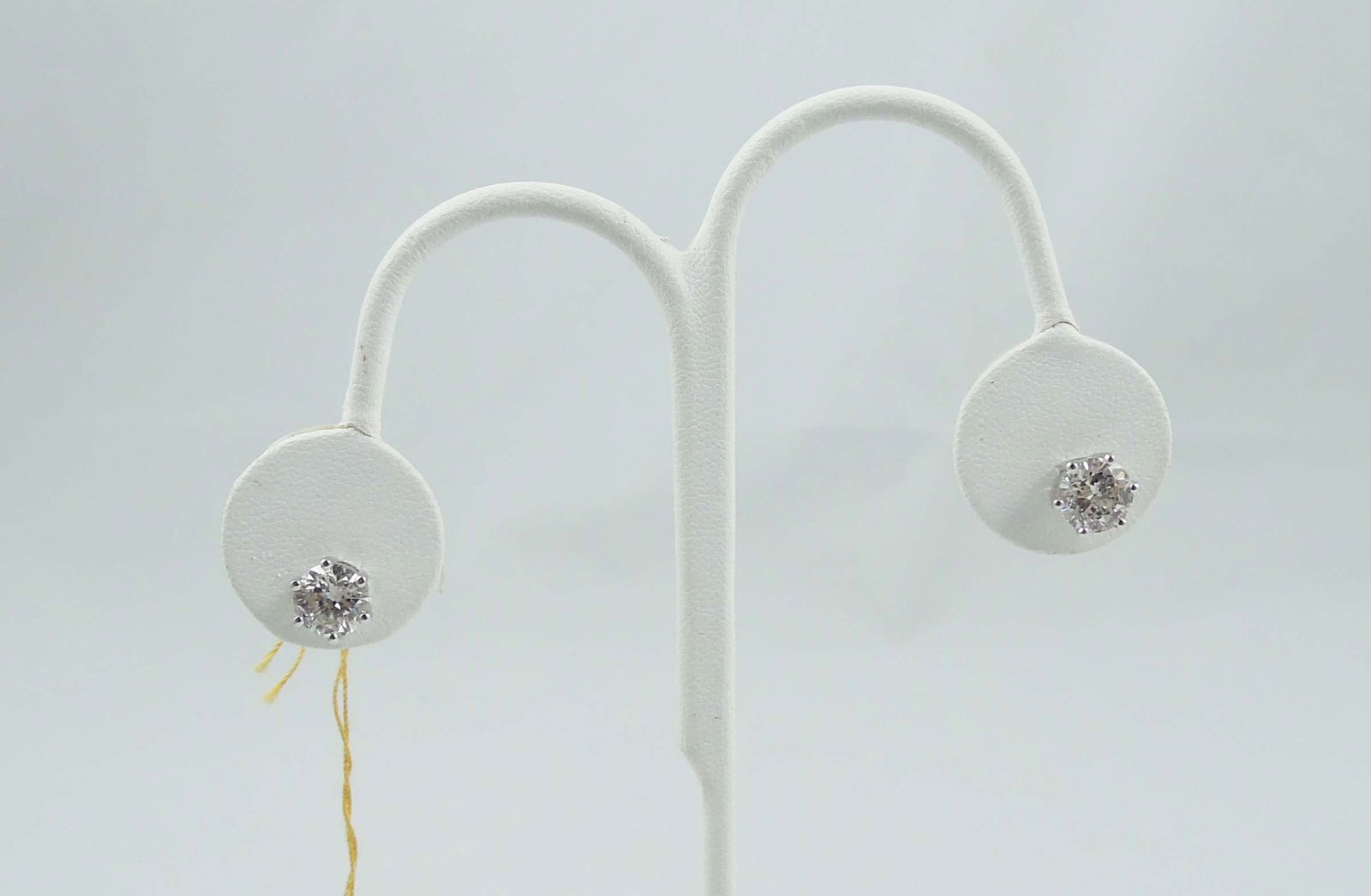 PAIR LADIES FINE 14K W.G. & DIAMOND STUD EARRINGS: A white gold six prong mount set with a full cut round diamond. I1 clarity, H-I color. Note: Diamonds face up brilliantly. Total diamond weight 3.04 cts. AIGL appraisal included.