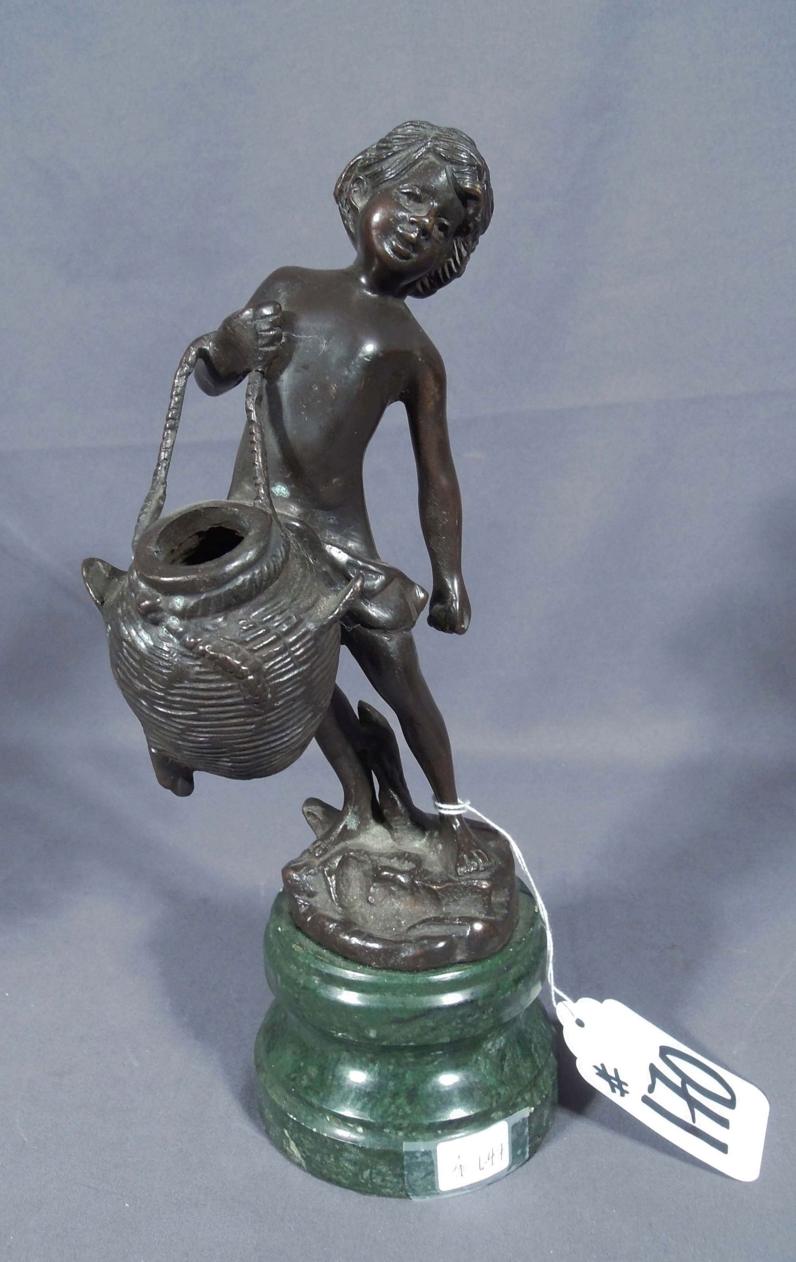 BRONZE SCULPTURE "WATER BARER": Young boy holding bucket. Brown patina. 11 1/2" high, 5" wide, 4 1/2" deep.