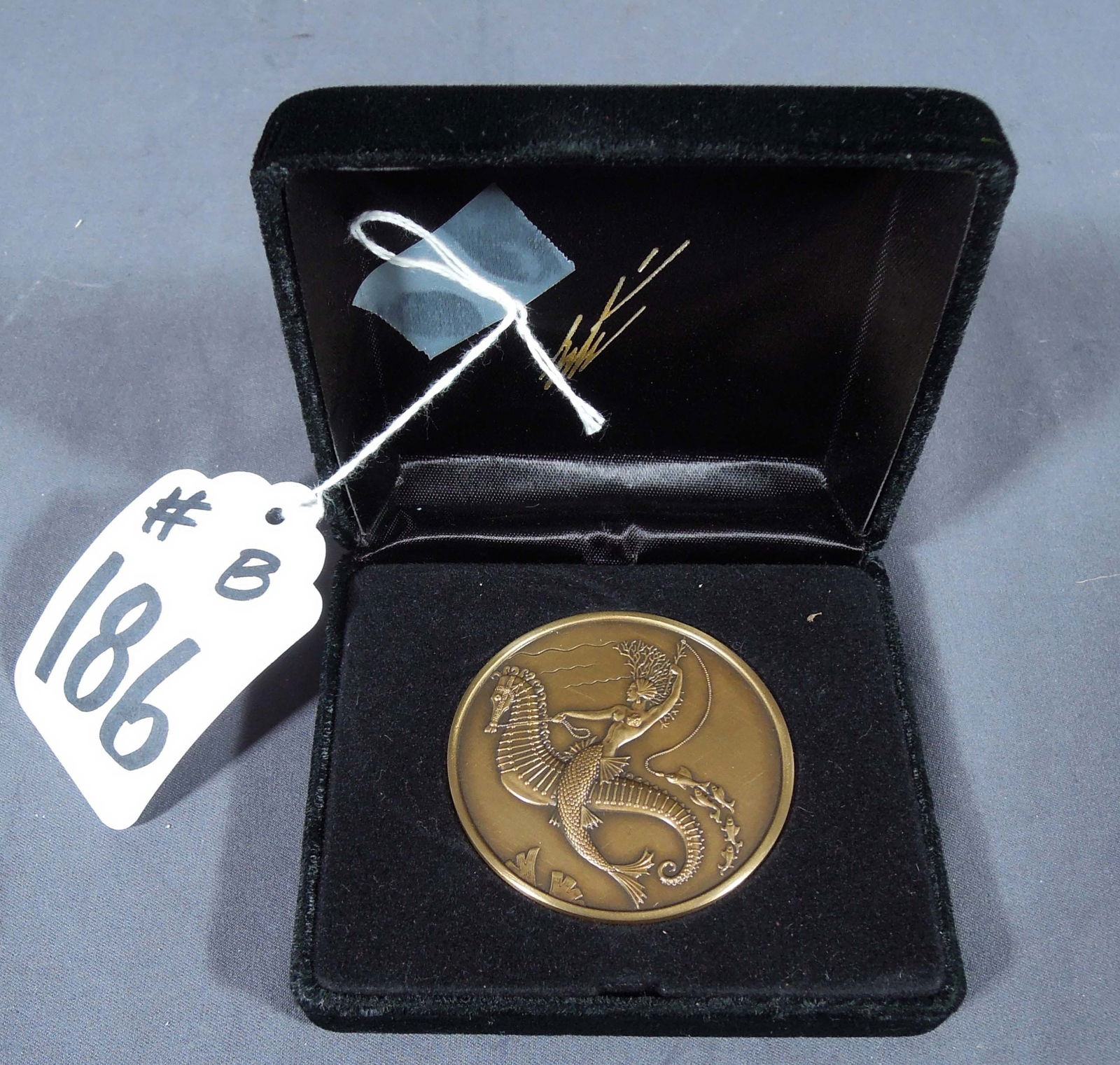 ROMAIN DE TIRTOFF (ERTE) (1892-1990) RUSSIAN/FRENCH: Rare Limited Edition bronze medallion. Publisher: Sevenarts Ltd. 667/1500. Circa 1989. Double sided with mermaid riding seahorse on on side and Embossed stylized Erte' signature on other. Fitted Erte'