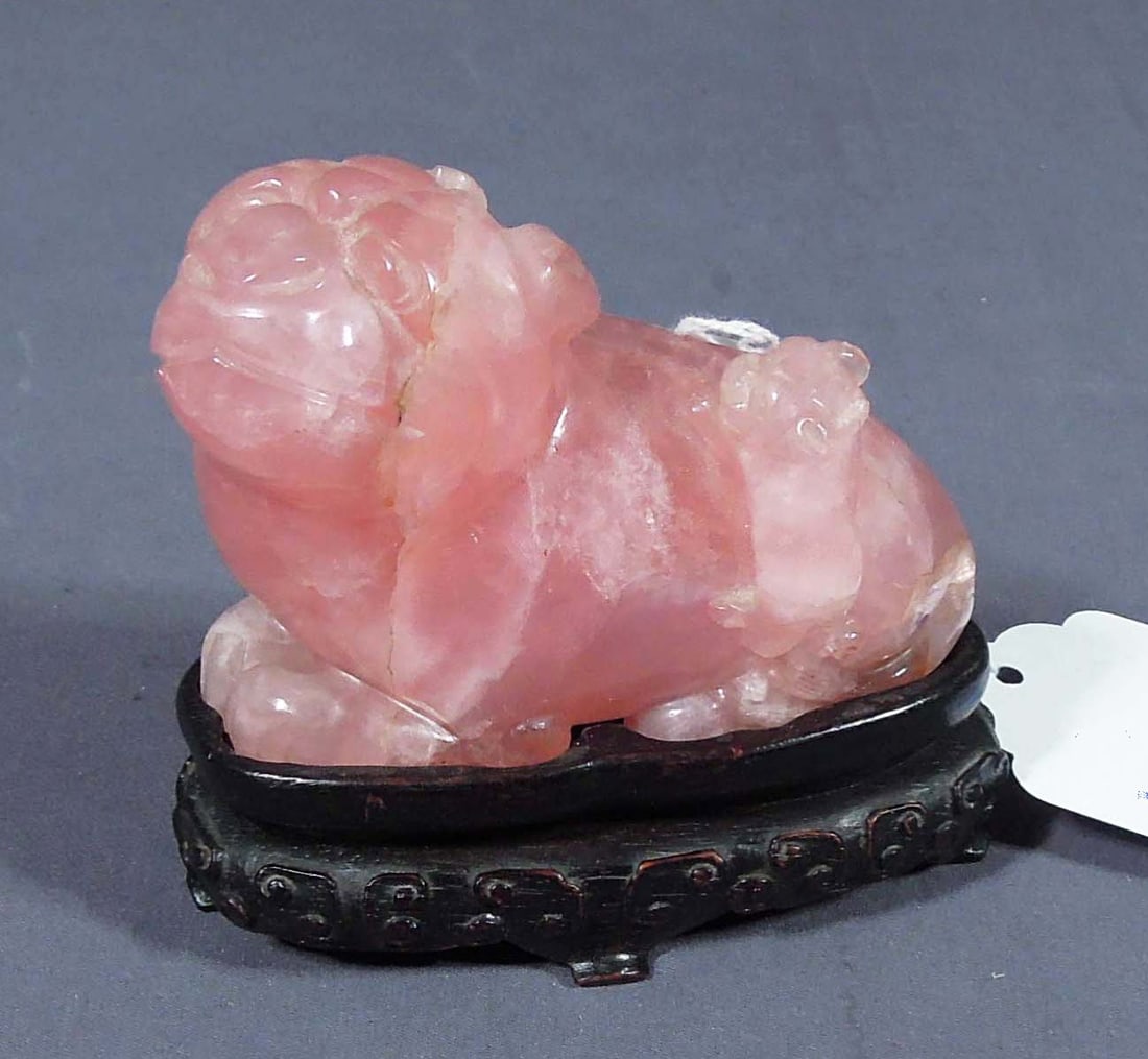 HAND CAVED ROSE QUARTZ FOO DOG ON ROSEWOOD STAND: 4" high, 4" wide, 2" deep.