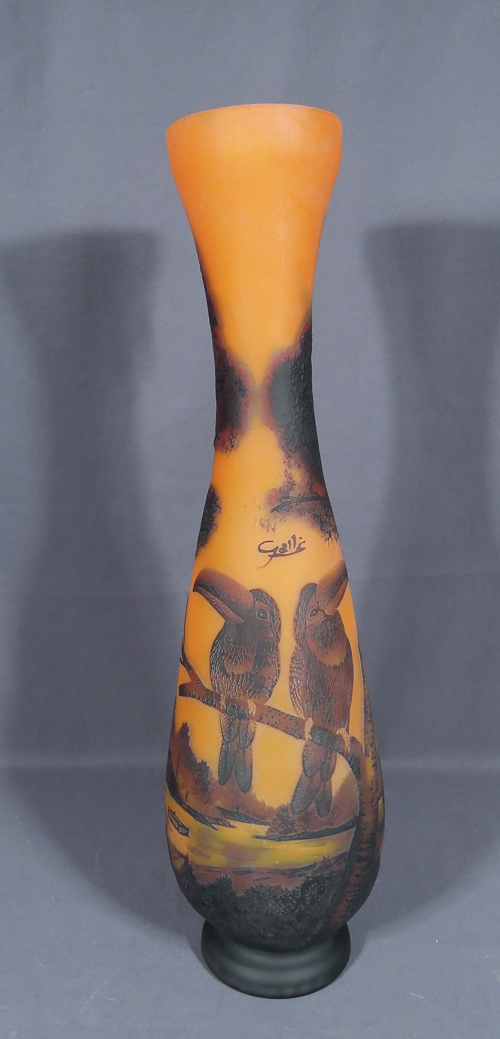 LARGE GALLE STYLE ACID ETCHED CAMEO ART GLASS VASE: Orange and brown colorations with two tucans perched on brance. Signed Galle. Marked on base "070ST. Excellent condition. 21 1/4" high, 5" dia.