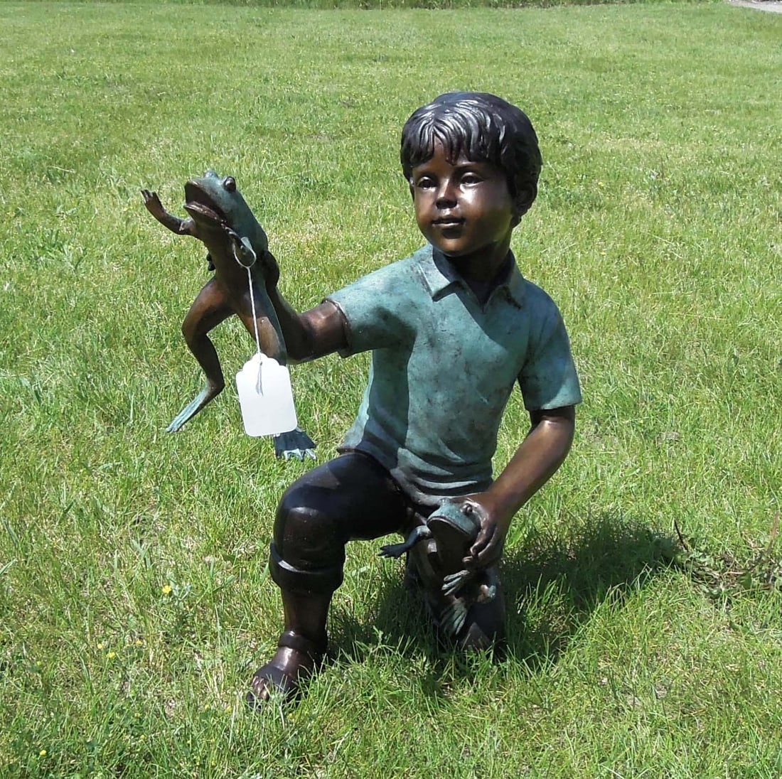 ADORABLE BRONZE SCULPTURE OF YOUNG BOY WITH FROGS: Young boy kneels on one knee while holding a frog in each hand. Excellent detail. Two color patina. 23" high, 11" wide, 19" deep.