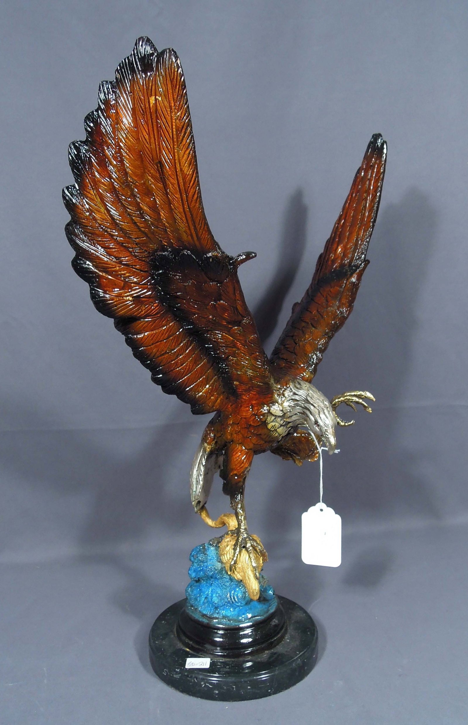 BRONZE SCULPTURE OF EAGLE WITH OUTSTRETCHED WINGS: Excellent detail. Eagle holds bird in talon. Black marble base. 23" high, 15" wide, 9" deep.