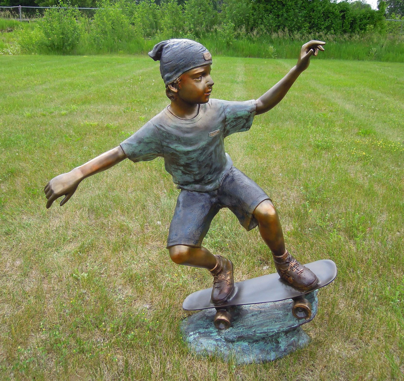 LIFE SIZE VINTAGE BRONZE SCULPTURE OF BOY RIDING SKATEBOARD: Great aged patina. Signed. 44" high, 39" wide, 21" deep.