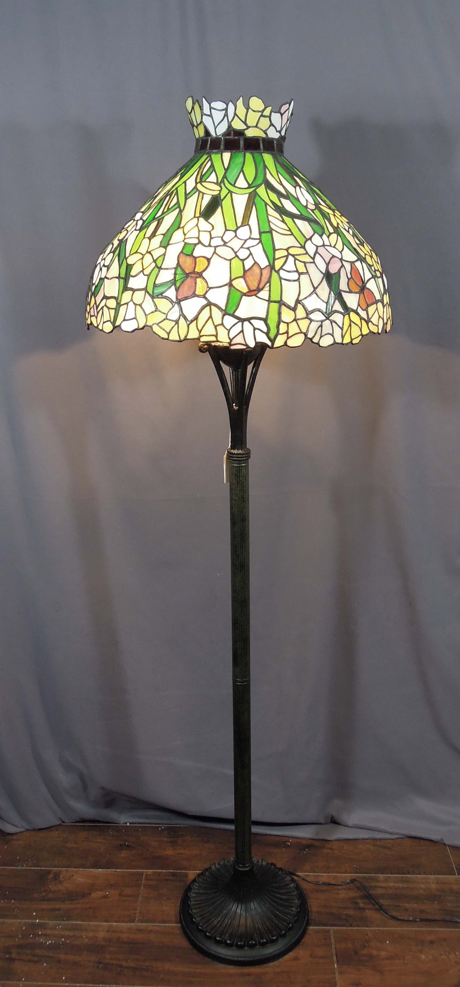 VERY UNUSUAL METAL & LEAD GLASS FLOOR LAMP: A heavy metal base supports an unusually shaped leaded glass shade with flowers and butterflies. Overall 68" high, 21 1/2" dia.