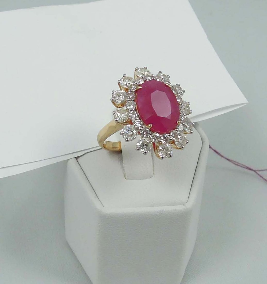 BEAUTIFUL DEISGNER OSCAR FREIDMAN 18K Y.G., BURMESE RUBY & DIAMOND RING: A yellow gold mount set with a GIA certified Burmese oval ruby weighing approx. 5.24 cts. Ring completed with two rows of full cut round diamonds totaling approx. 3.11 cts. Ruby has GIA certificate.