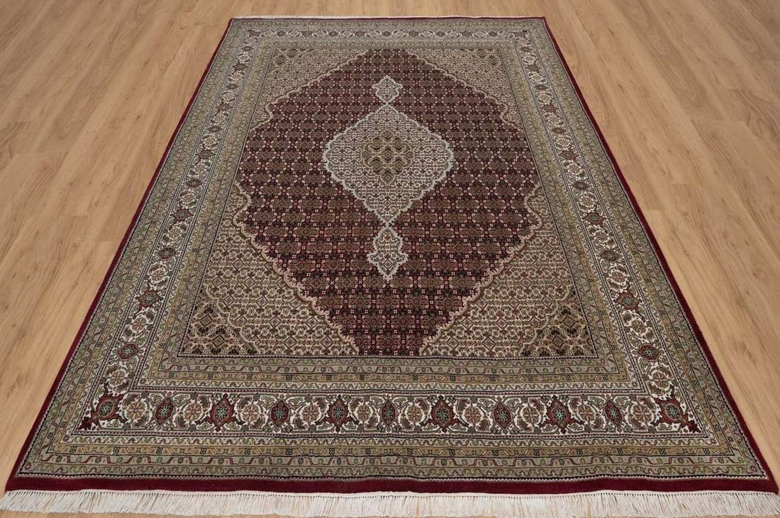 FINE HAND KNOTTED MAHI TABRIZ AREA RUG: Soft wool rug with carmine red ground. Excellent condition. 7'8" x 9'10".