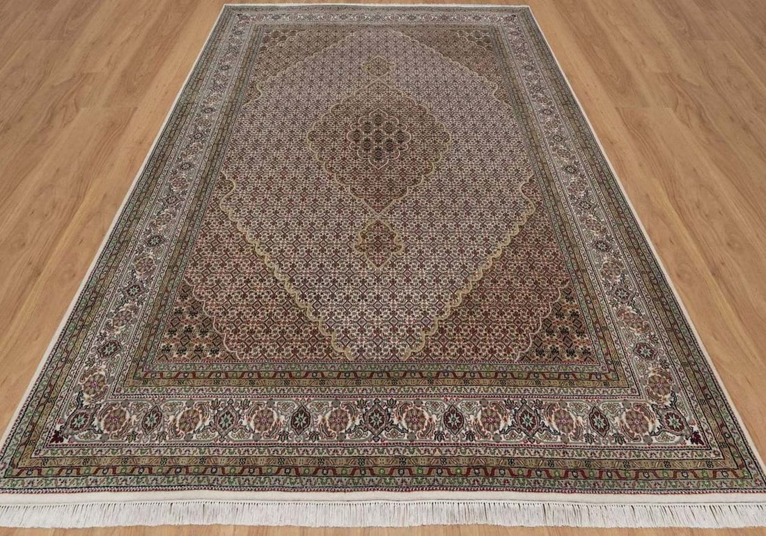 FINE HAND KNOTTED MAHI TABRIZ AREA RUG: 100% wool. Excellent condition. Beige colorations. 9' x 11.10.