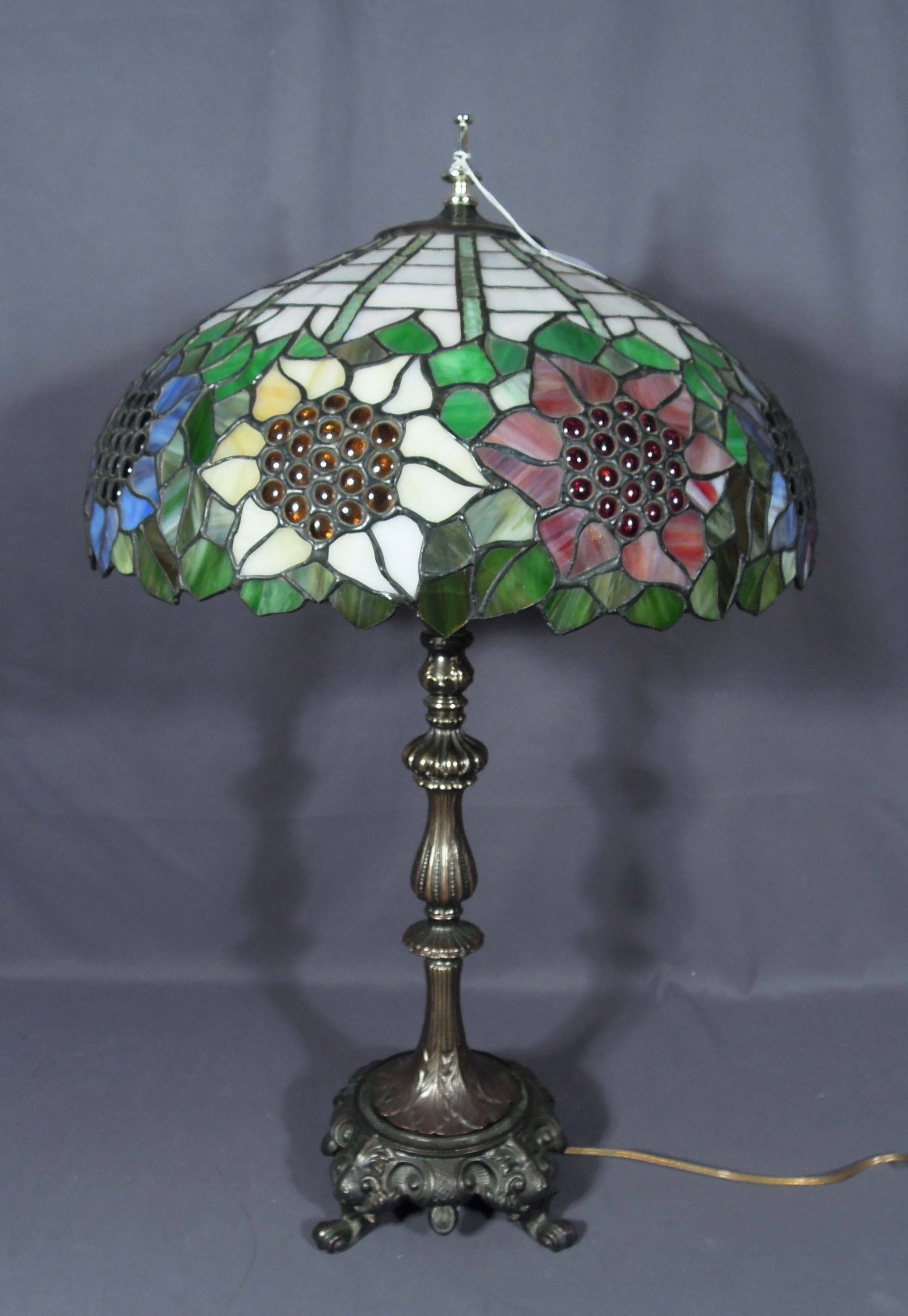 BEAUTIFUL METAL & LEADED GLASS TABLE LAMP: Ornate metal base supports a domed floral & grape motif leaded glass shade. 31" high, 18" dia.