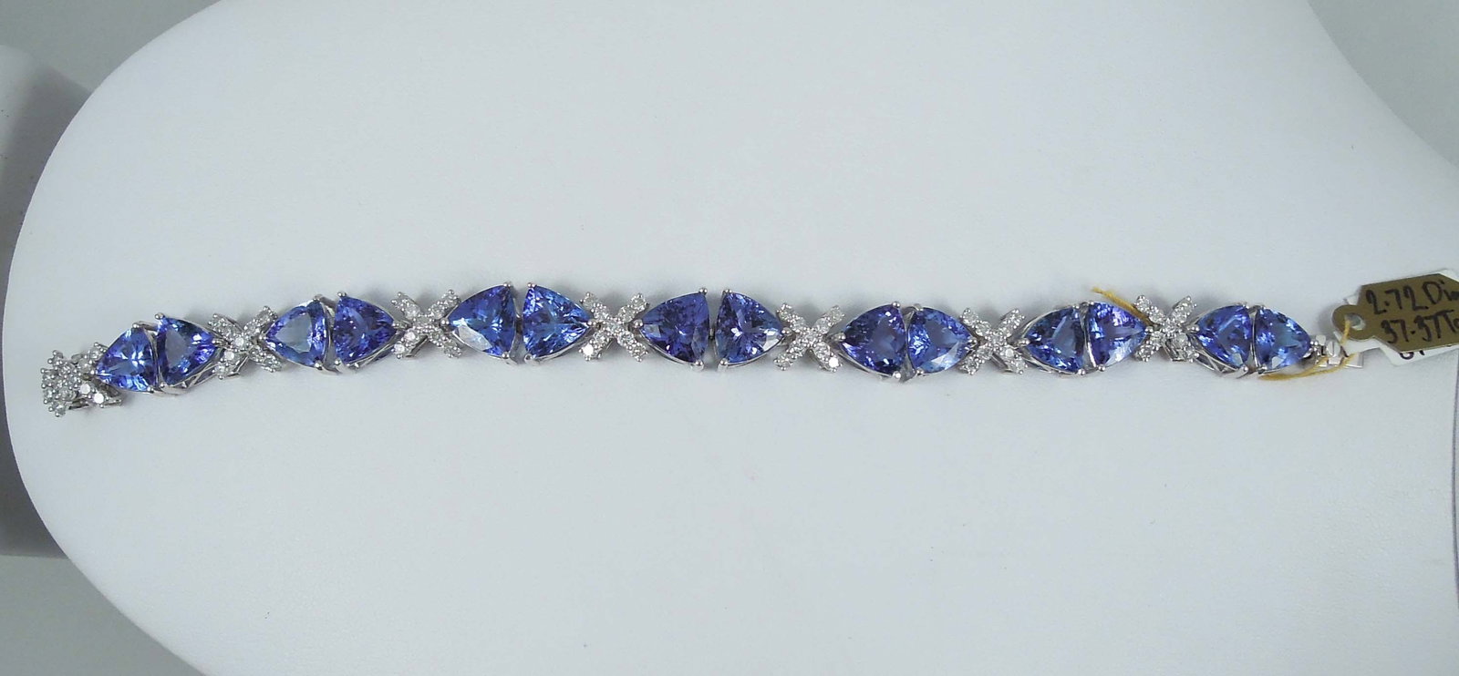 SPECTACULAR LADIES PLATINUM, TANZANITE & DIAMOND BRACELET: A straight row bracelet set with beautiful triangular cut tnzanite of fine color (violetish blue). Tanzanite total approx. 37.37 cts. Bracelet finished with fine full cut round diamonds totaling