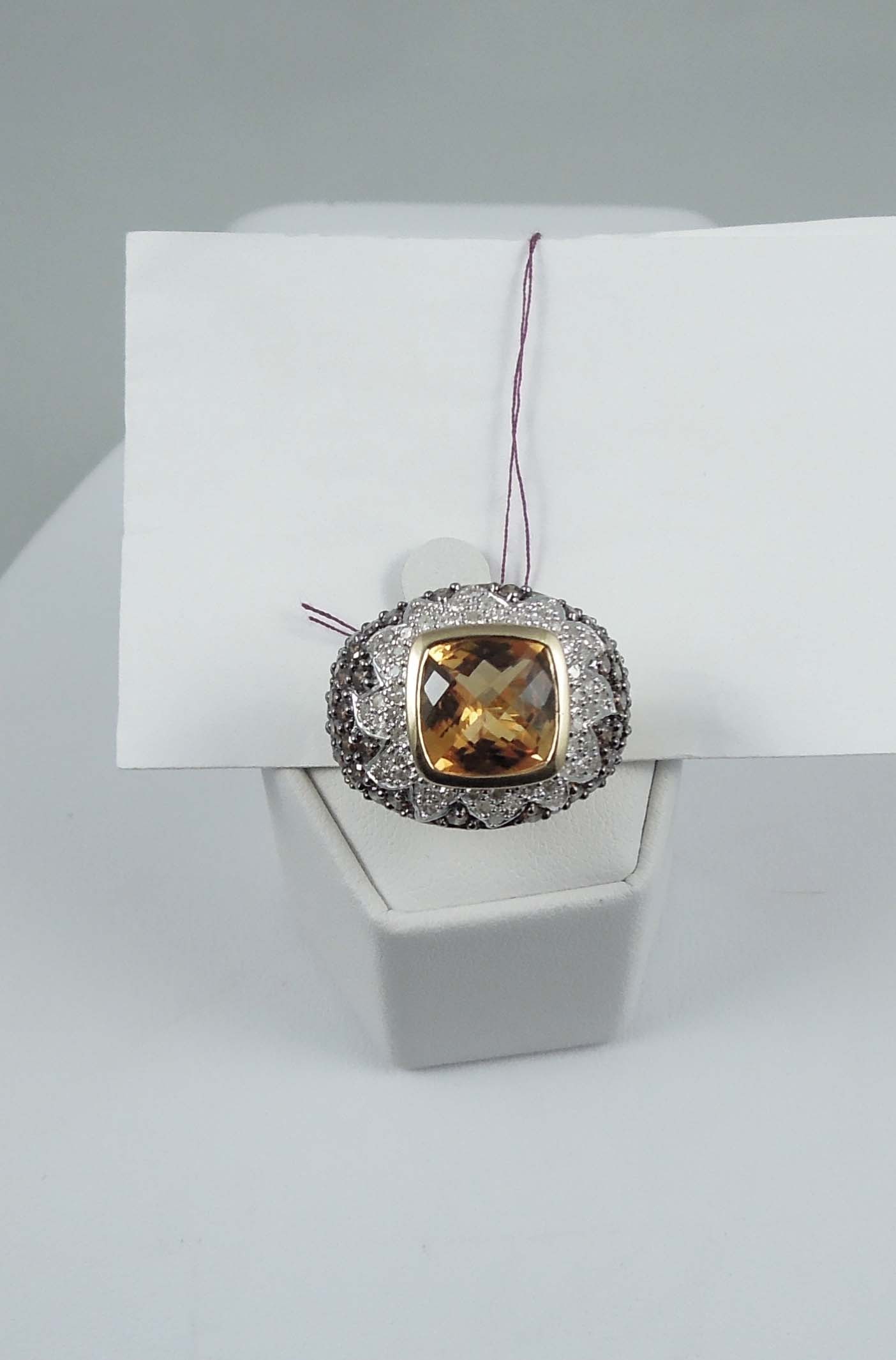 LADIES 10K Y.G. & W.G., CITRINE AND CHAMPAGNE & WHITE DIAMOND RING: A wide mount set with a faceted citrine weighing approx. 4 cts. Ring encrusted with champagne and white full cut round diamonds totaling approx. 2.50 cts.