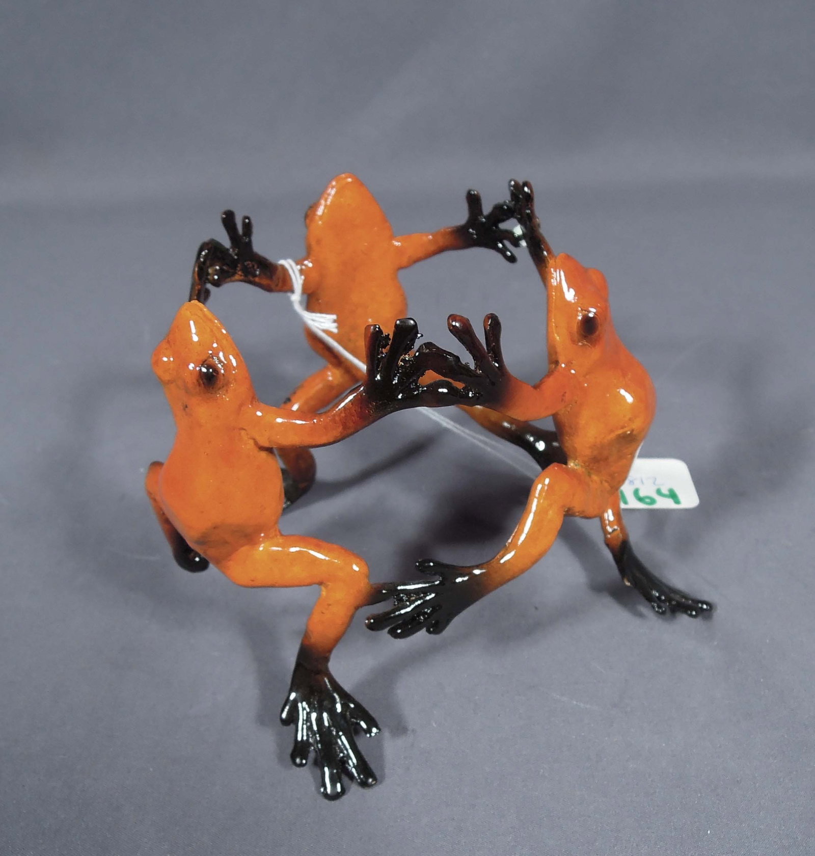 HUMOROUS BRONZE TRIPLE FROG WINE HOLDER: Three frogs hold hands. 4 1/4" high, 5: dia.