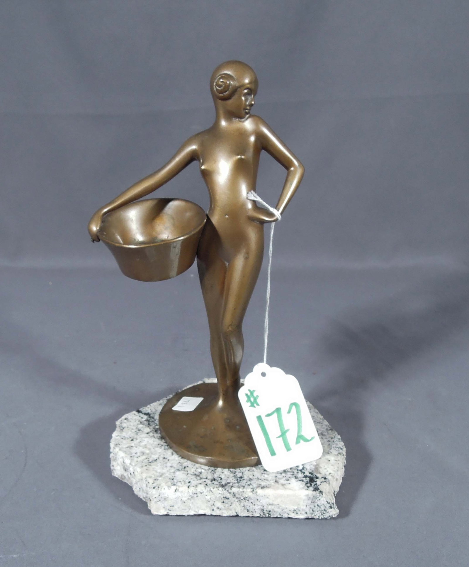 SMALL SCALE ART DECO BRONZE SCULPTURE OF WOMAN: Nude woman holding basket. 9" high, 5 1/4" wide, 4" deep.