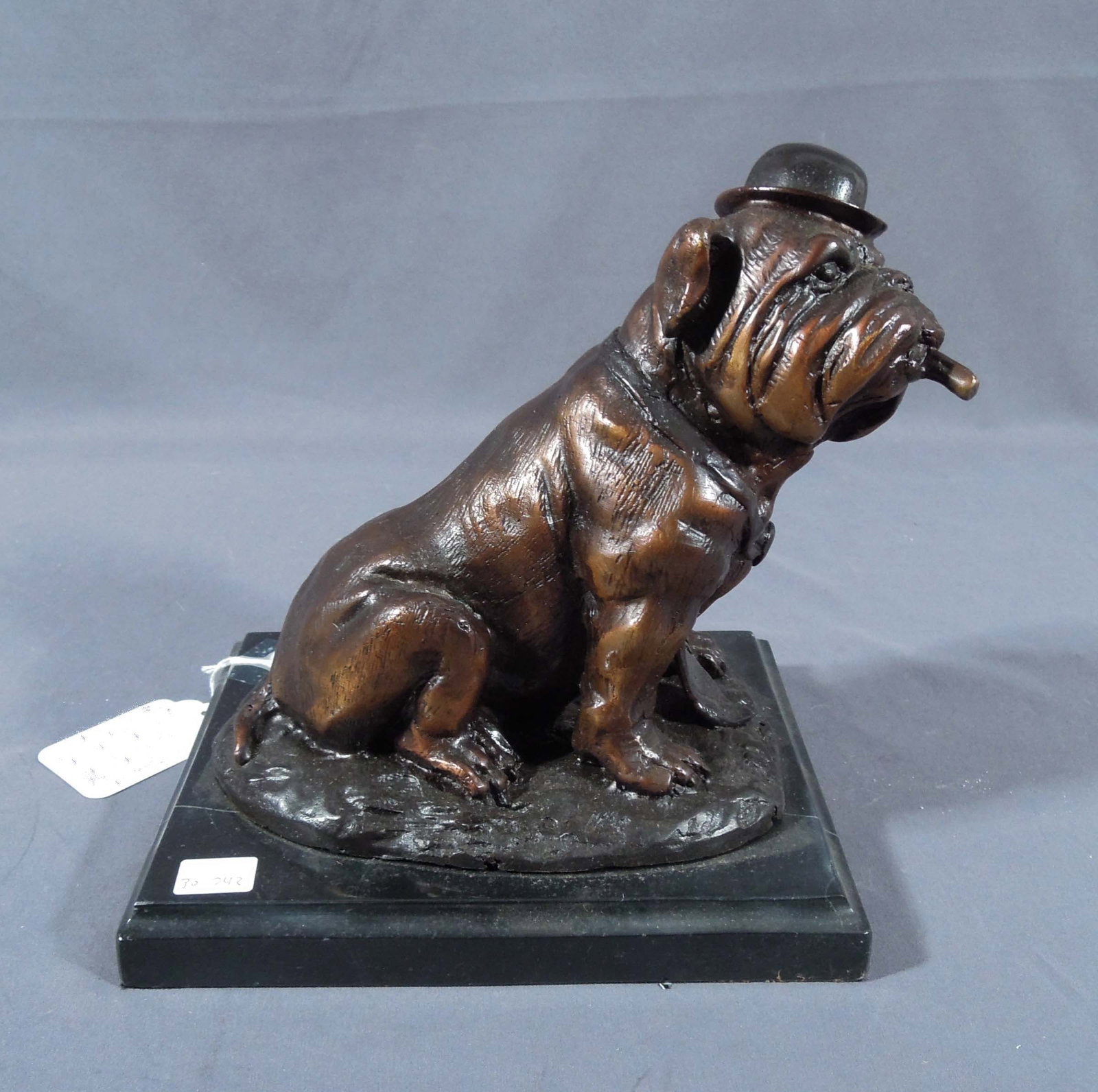 HUMOROUS BRONZE SCULPTURE OF SEATED BULLDOG WITH TOP HAT AND CIGAR: Excellent detail. Brown patina. Black marble base. 9" high, 8 1/2" wide, 7" deep.
