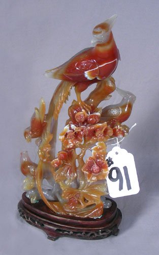 HAND CARVED CHINESE HARD STONE SCULPTURE OF PHOENIX: HAND CARVED CHINESE HARD STONE SCULPTURE OF PHOENIX BIRDS Beautiful sculpture, possibly carnelian of phoenix birds in a flowering tree. Fitted stand. 11 3/4" high, 6" wide