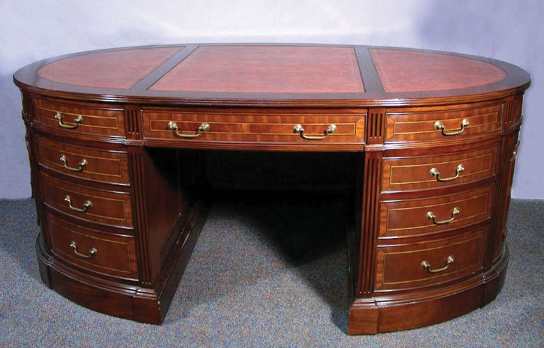 HAND CARVED ENGLISH MAHOGANY PARTNER'S DESK WITH: HAND CARVED ENGLISH MAHOGANY PARTNER'S DESK WITH LEATHER TOP Burrowed mahogany desk with inlay on drawers. Each side of desk with nine drawers with brass handles. Top of desk with three leather sectio