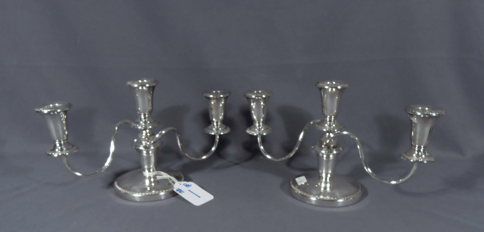 PAIR OF SHEFFIELD SILVER COMPANY SILVER PLATED CANDELABRA: Swirl arms. 7 1/2" high, 12" wide, 5" deep.
