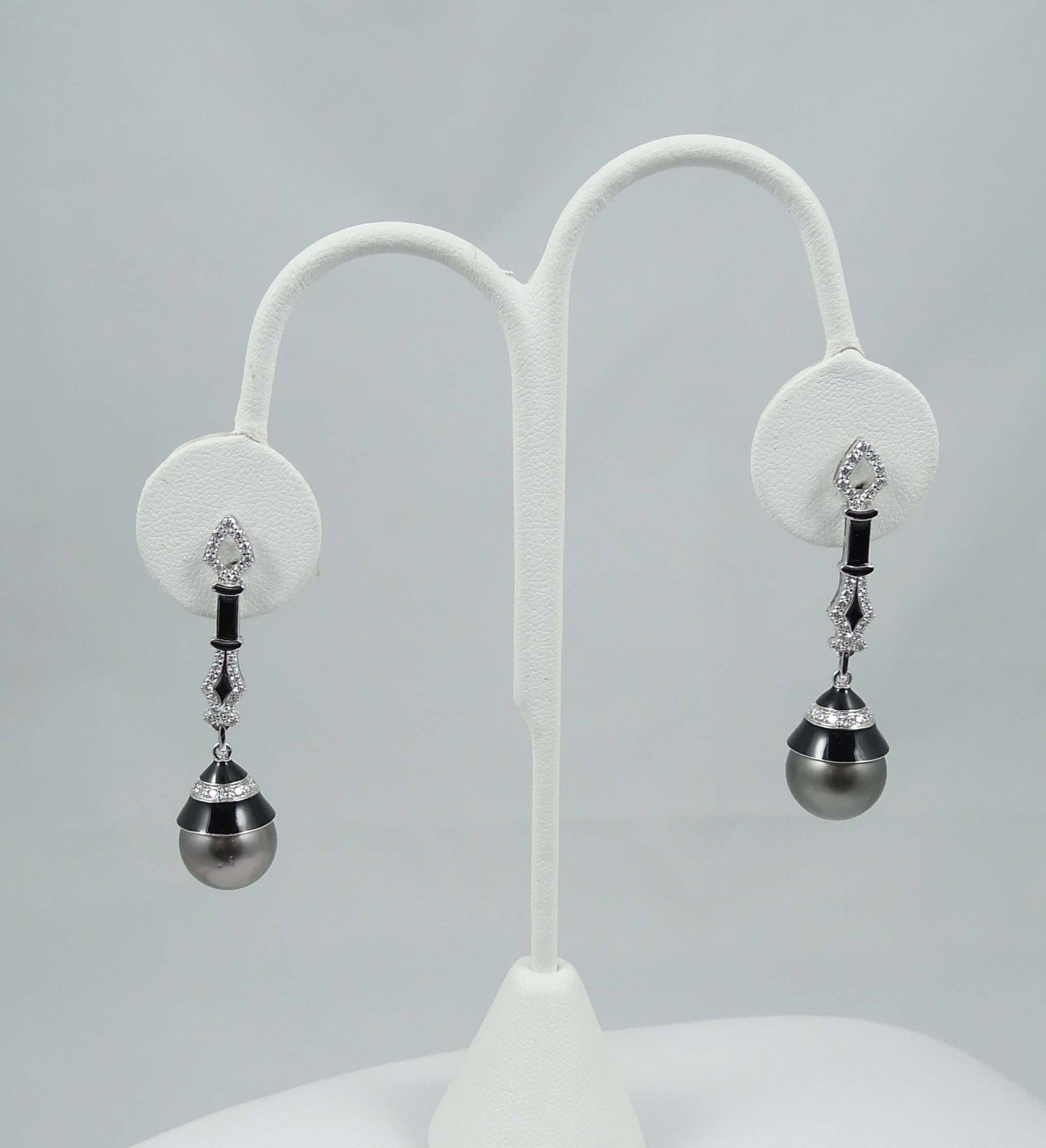 PAIR LADIES 14K W.G., BLACK/GRAY SOUTH SEA TAHITIAN PEARL AND DIAMOND EARRINGS: A dangle earring with a diamond top with enamel supports a South Sea pearl measuring approx. 12mm. Earrings complete with full cut round diamonds totaling approx. .85 ct. VS1-VS2 clarity, F-G color. D