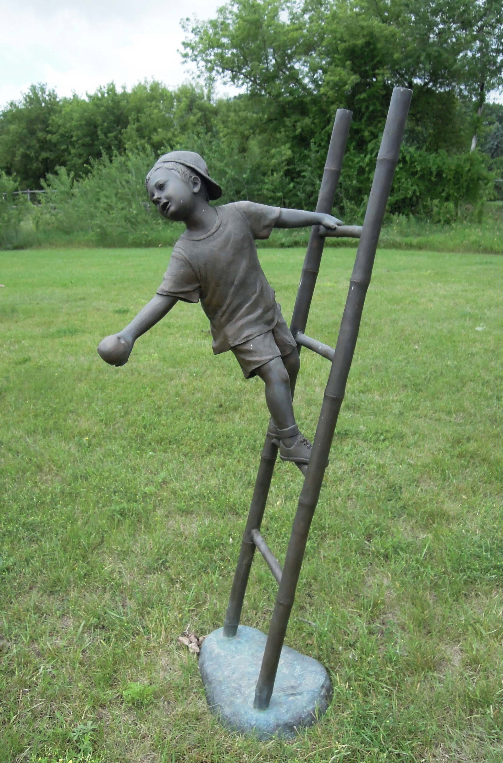 LARGE VINTAGE BRONZE SCULPTURE OF YOUNG BOY STANDING ON LADDER: 67 1/2" high, 19" wide, 26" deep.