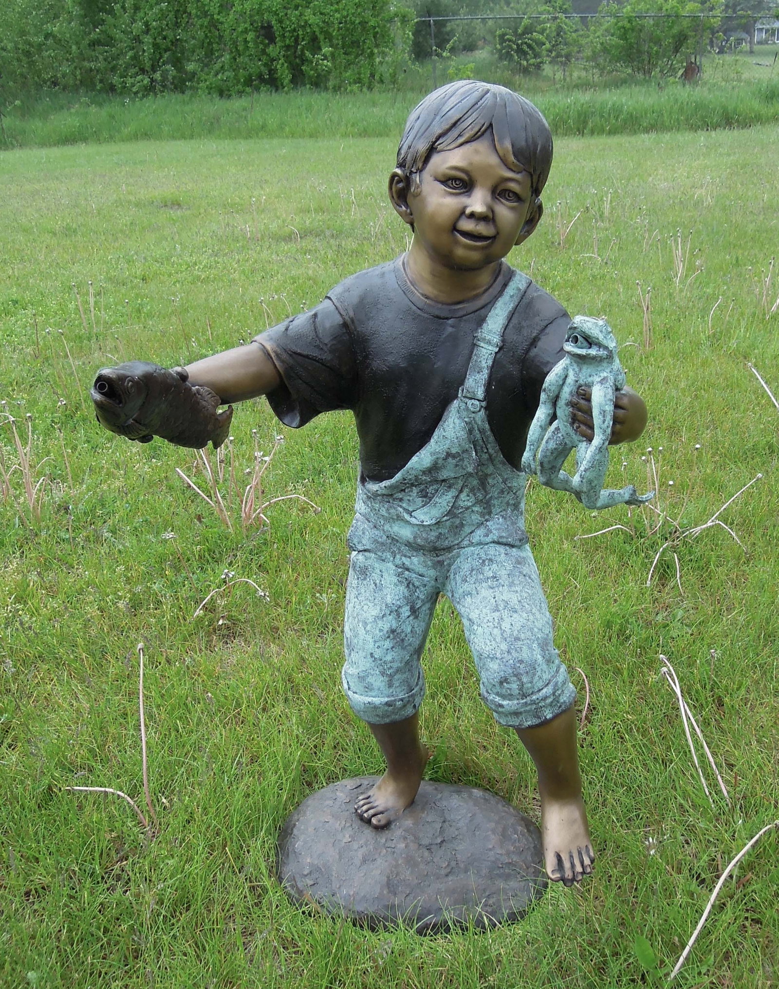 LIFE SIZE BRONZE SCULPTURE/FOUNTAIN OF YOUNG BOY WITH FROG AND FISH: Young boy holds a fish in one hand and frog in other. Very fine detail. Two color patina. Note: Water emerges from fish and frogs mouths when used as a fountain. 38" high, 19" wide, 20" deep