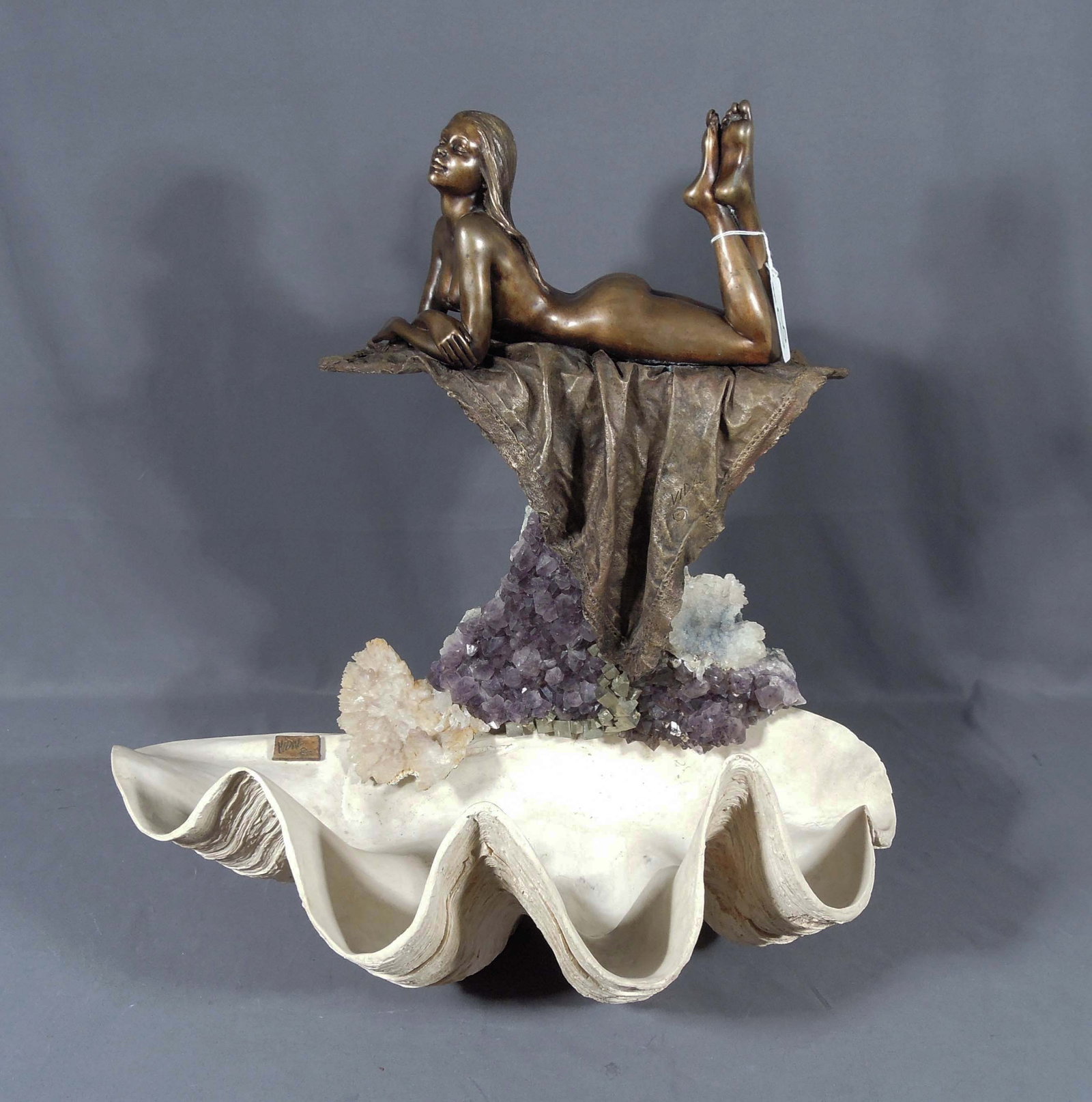 MANUEL VIDAL (1953- ) SPANISH: Original bronze, amethyst and rock crystal sculpture "Sentuality". A beautiful seated bronze woman upon an amethyst and rock crystal plinth. Base a composition sea shell. 24" high, 22" wide, 14" deep.