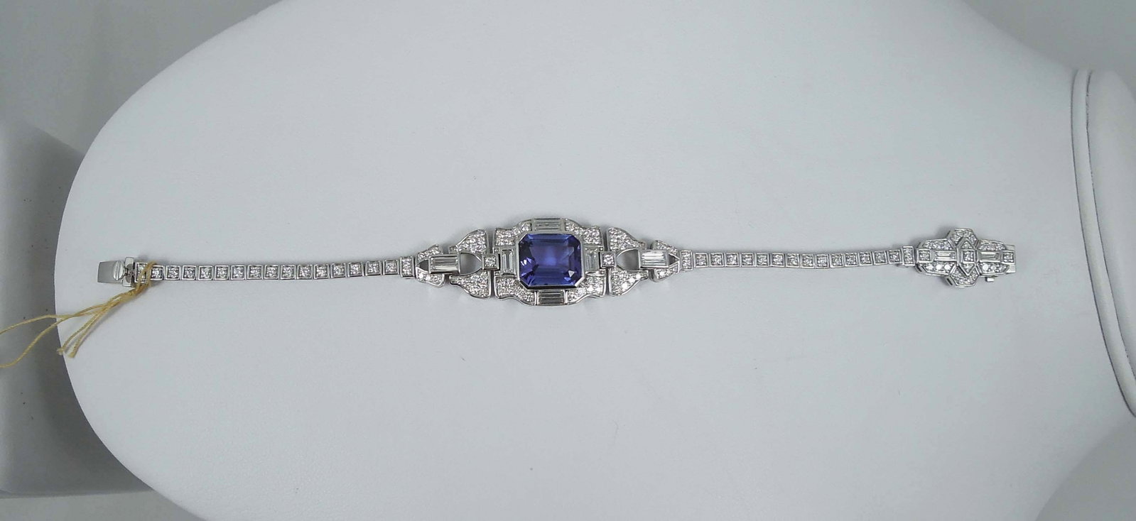 SPECTACULAR LADIES PLATINUM, ART DECO STYLE TANZANITE & DIAMOND BRACELET: A beautiful bracelet with a fine octagonal step cut tanzanite with violetish blue intense color weighing approx. 5.84 cts. Bracelet completed with baguette and full cut round fine diamonds averaging V