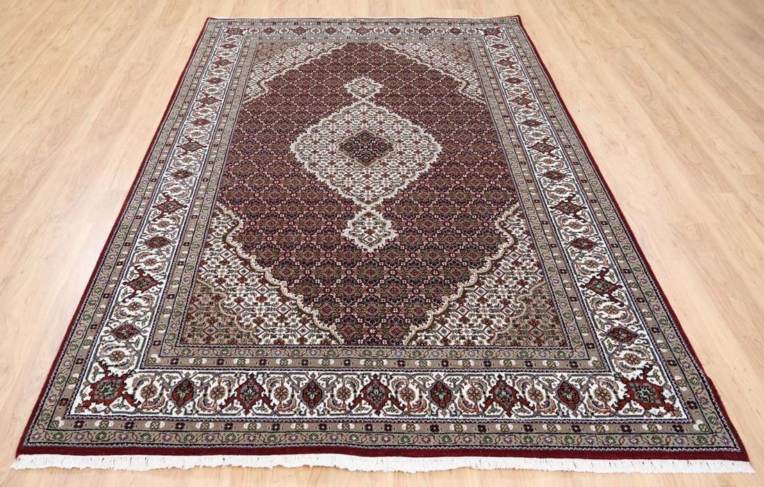 FINE HAND KNOTTED MAHI TABRIZ AREA RUG: Excellent condition. Red ground. 5'9" x 9'.