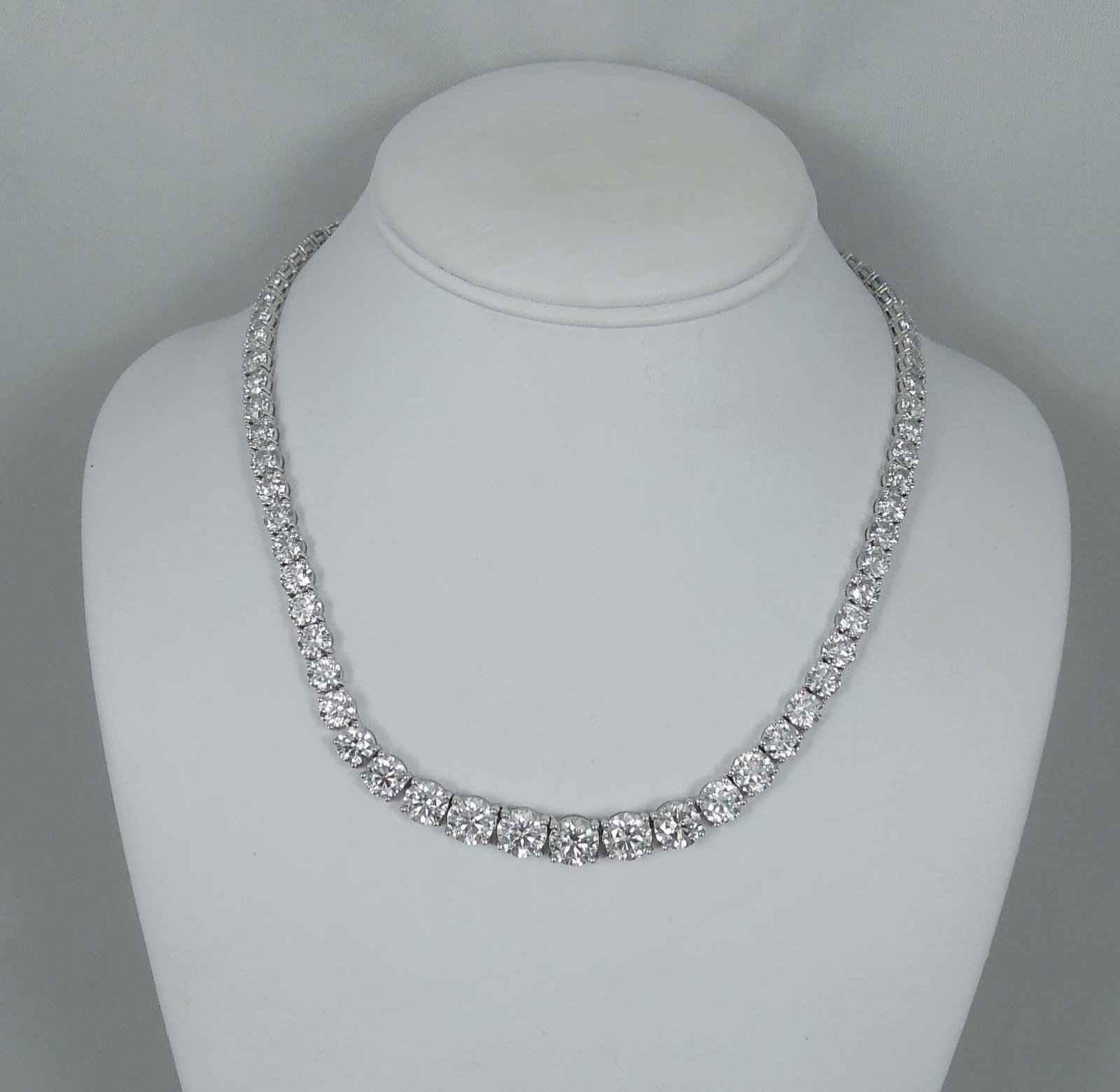 LADIES SPECTACULAR PLATINUM & GRADUATED DIAMOND ETERNITY NECKLACE: A 17 1/4" necklace set with fine graduated full cut round diamonds totaling 56.16 cts. Complete with GGA appraisal. Clarity range I2-SI1, Color G-H. This necklace faces up beautifully.