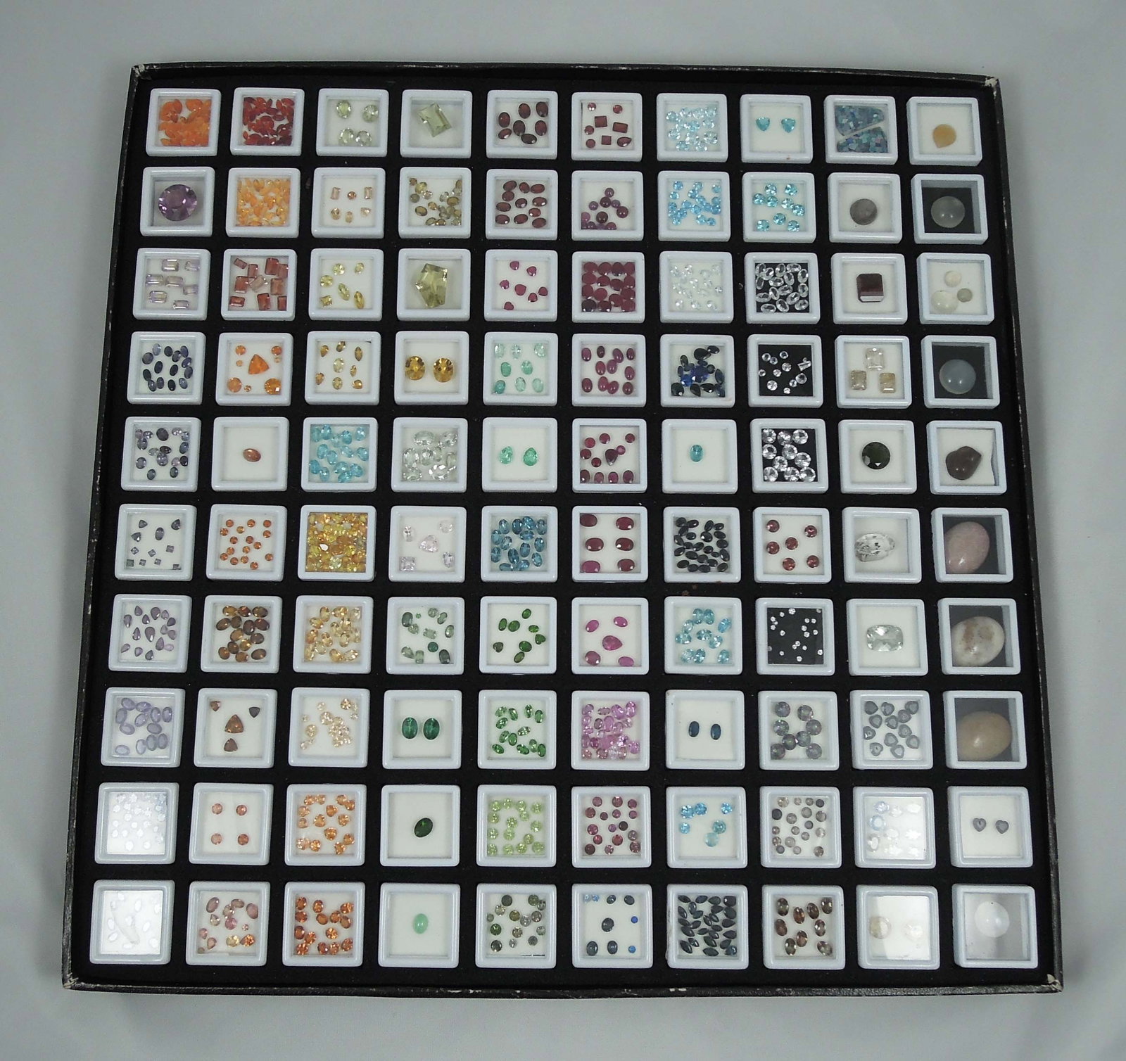 VERY HIGH END BOX OF NATURAL GEMSTONES: 100's of cts. This box includes mandarin orange garnet, amethyst, kunsite, iolite, emeralds, sapphires, rubies, herkimer diamonds and more