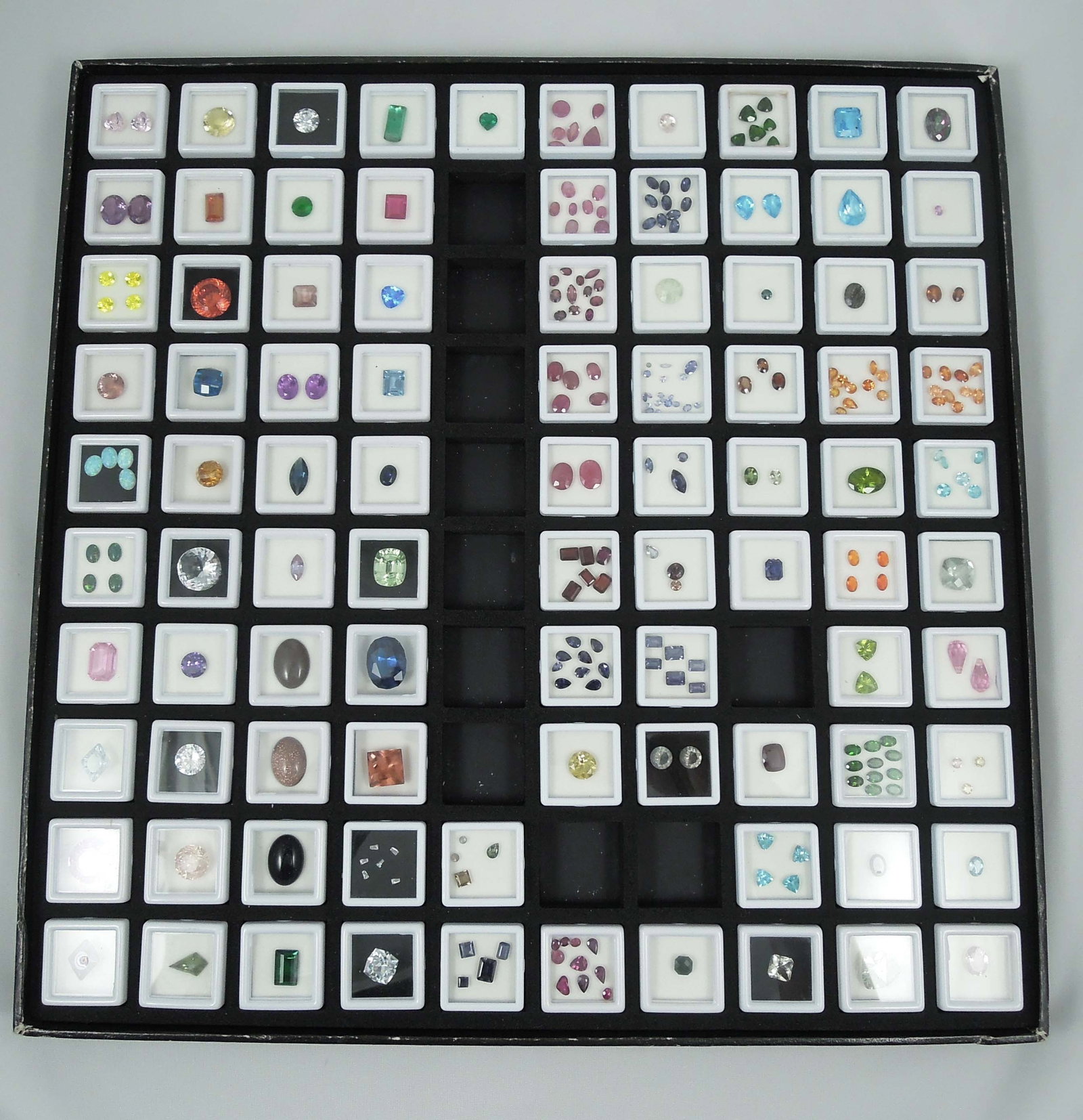 LARGE CASED GROUP OF MANY NATURAL GEMSTONES: 100's cts. of gemstones. Including tourmaline, blue topaz, peridot, chattam emeralds, kunsite, amethyst and more. Very few synthetic.