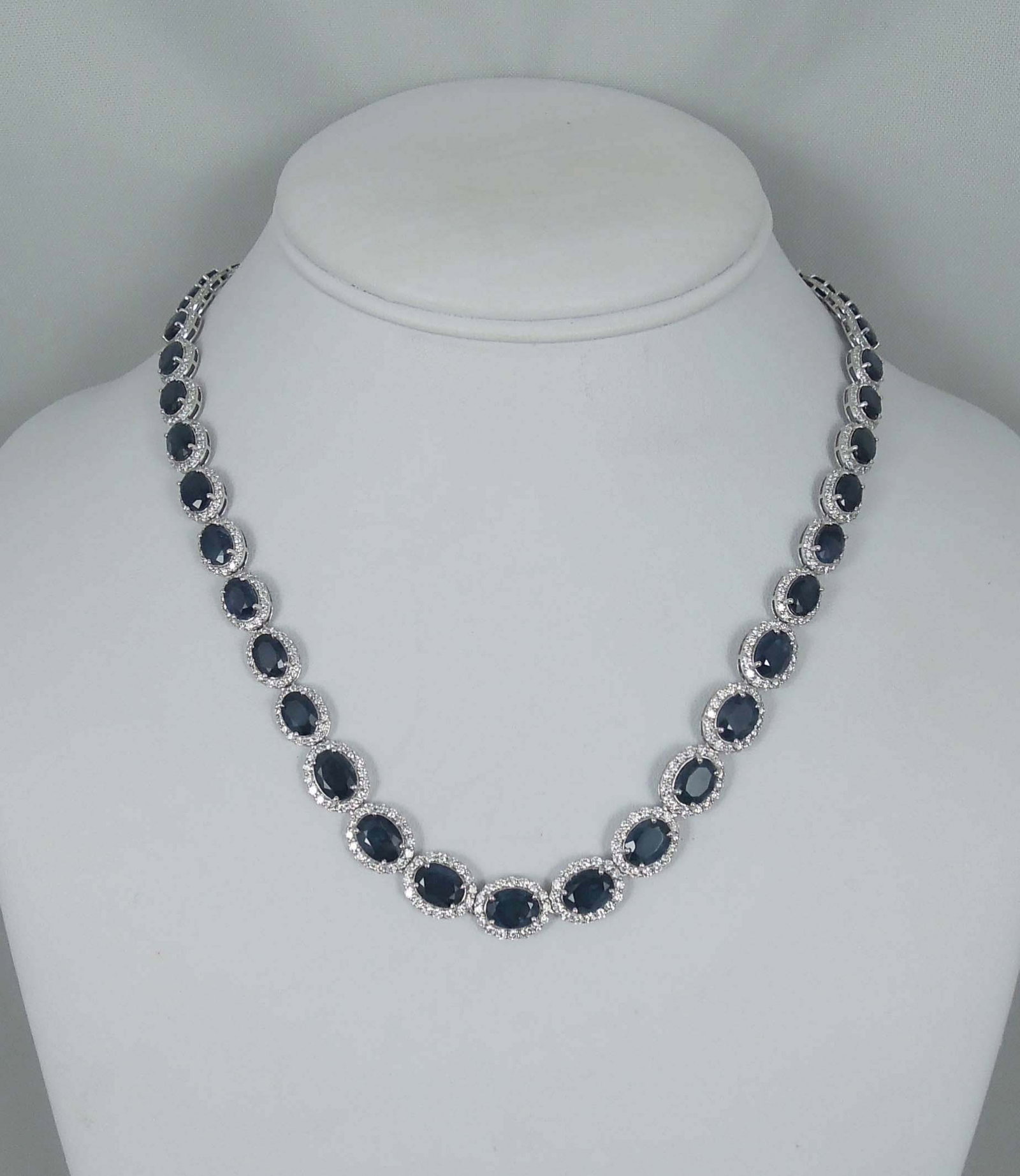 LADIES BEAUTIFUL 17" PLATINUM, SAPPHIRE & DIAMOND ETERNITY NECKLACE: A straight row platinum necklace set with multifple oval sections each wih a very fine oval cut blue sapphire with excellent color. Each sapphire surround by a single row of full cut round diamonds. T