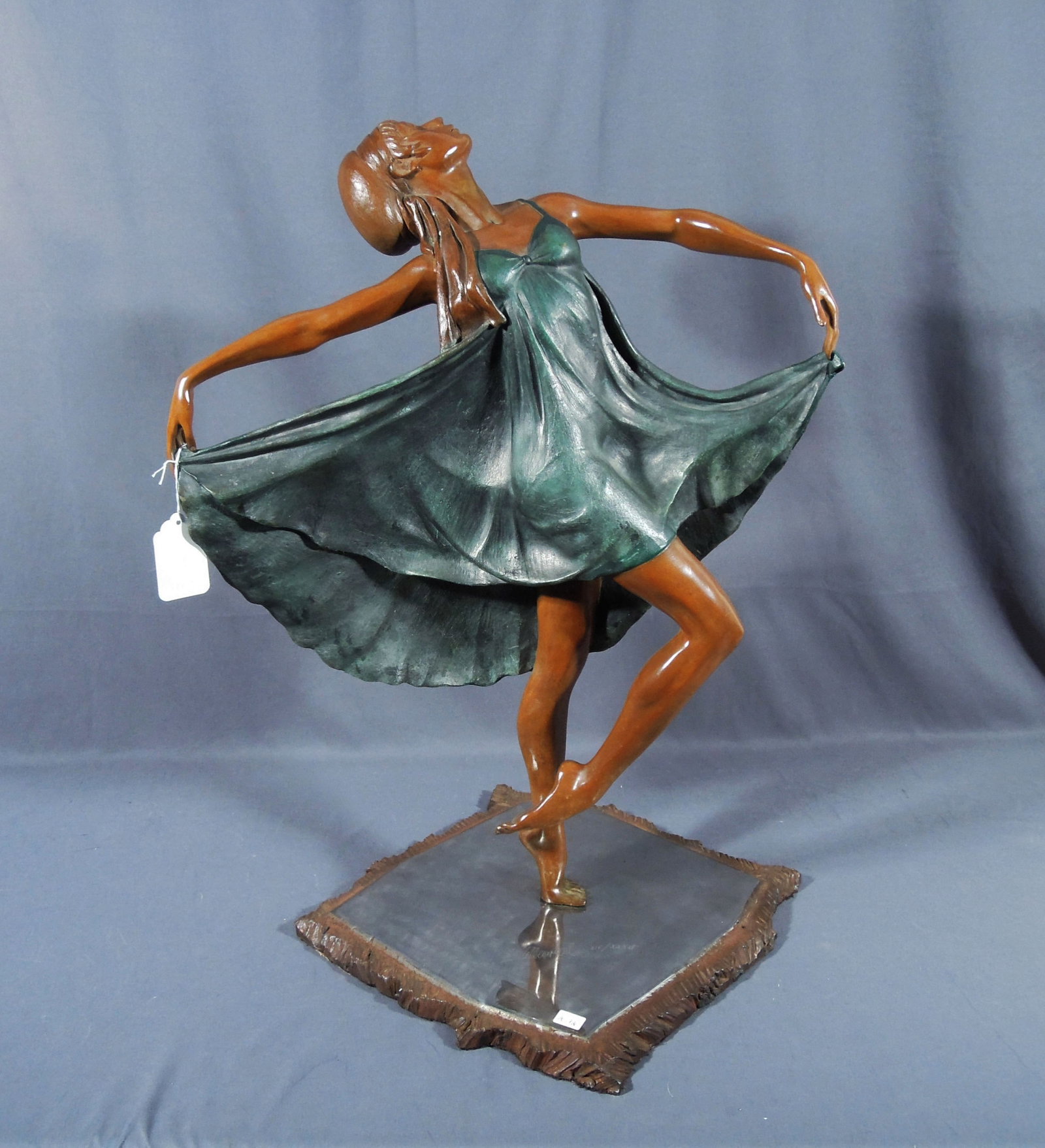 JAVIER VILLARREAL (20TH C.) MEXICAN: Beautiful bronze sculpture of ballerina striking a pose. Two color patina. Heavy base with mirrored looking top. Signed and numbered on base XIV/XXXVI. 29" high, 21" wide, 19" deep.