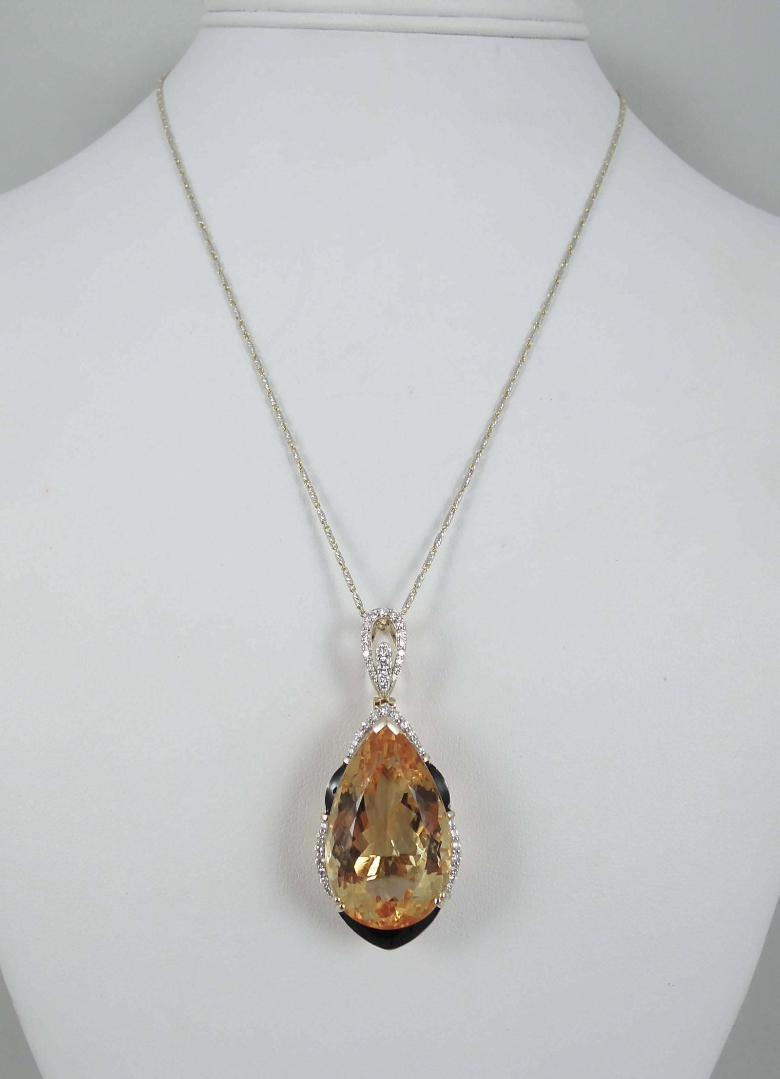 BEAUTIFUL LADIES 14K Y.G., CITRINE, ENAMEL AND DIAMOND NECKLACE: A 14k yellow and white gold chain supports a large pear shaped pendant set with a very fine pear shaped citrine weighing 35.10 cts. Necklace completed with full cut round diamonds totaling approx. .47