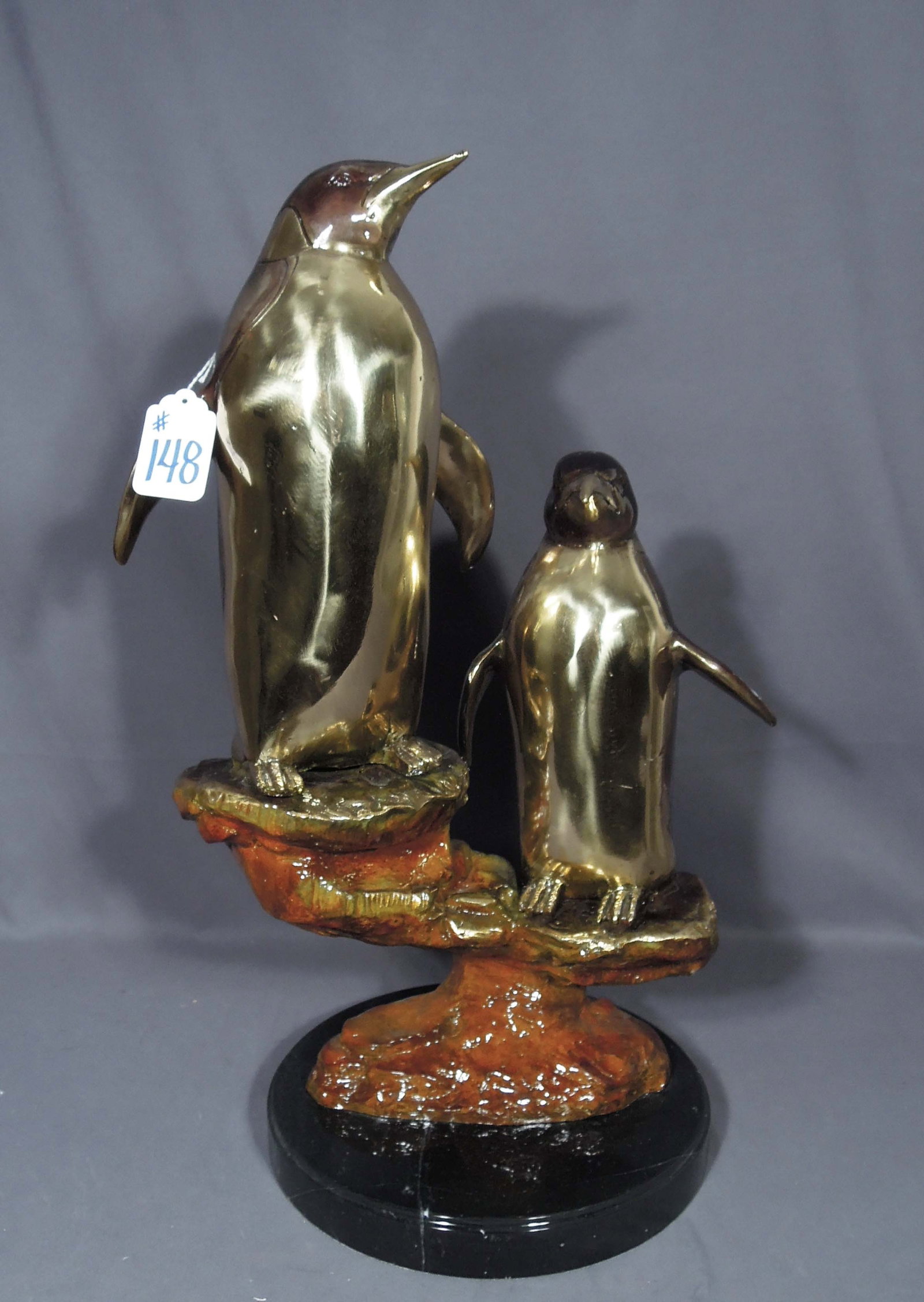 LARGE ORIGINAL BRONZE SCULPTURE OF TWO PENGUINS STANDING ON ROCK: Very fine detail. Three color patina. Black marble base. 27" high, 18" wide, 12 1/2" deep.