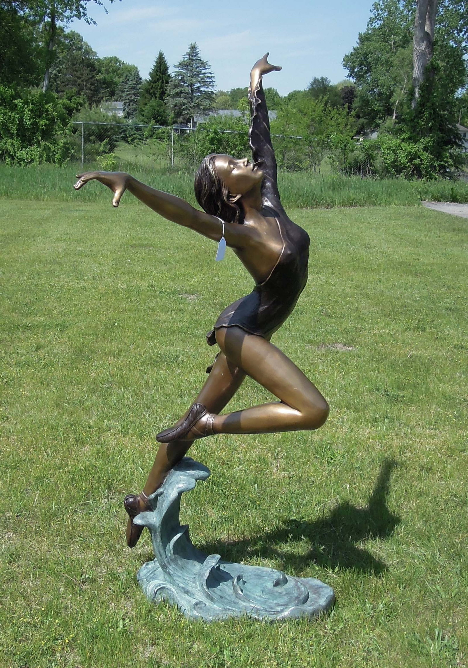 FABULOUS LIFE SIZE BRONZE SCULPTURE OF WOMAN DANCING ON WAVE: Excellent detail. Three color patina. 73" high, 44" wide, 32" deep.