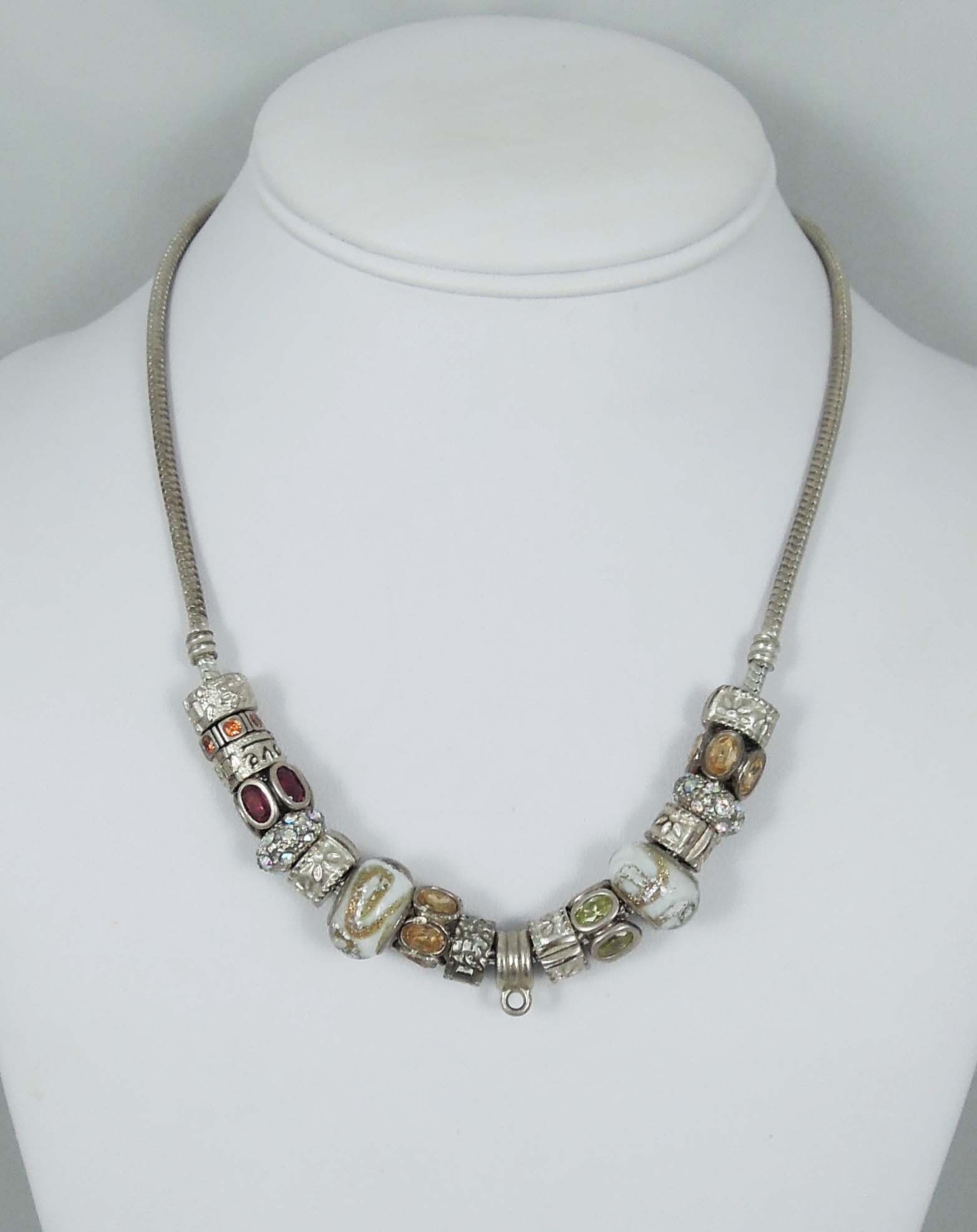 VINTAGE LADIES STERLING SILVER PANDORA CHARM NECKLACE: A heavy snake chain necklace with multiple charms. Signed. Weighs 62.4 grams.