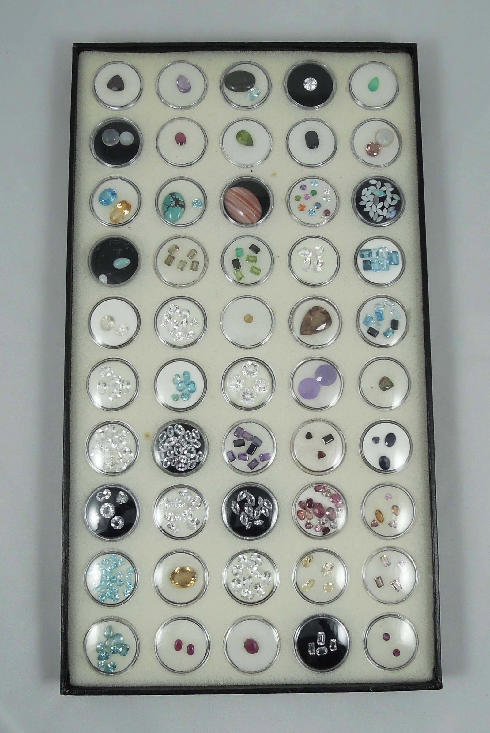 CASED BOX OF 100'S CTS. OF NATURAL GEMSTONES: Including opal, amethyst, peridot, lavender jade, tourmaline, blue topaz and more.