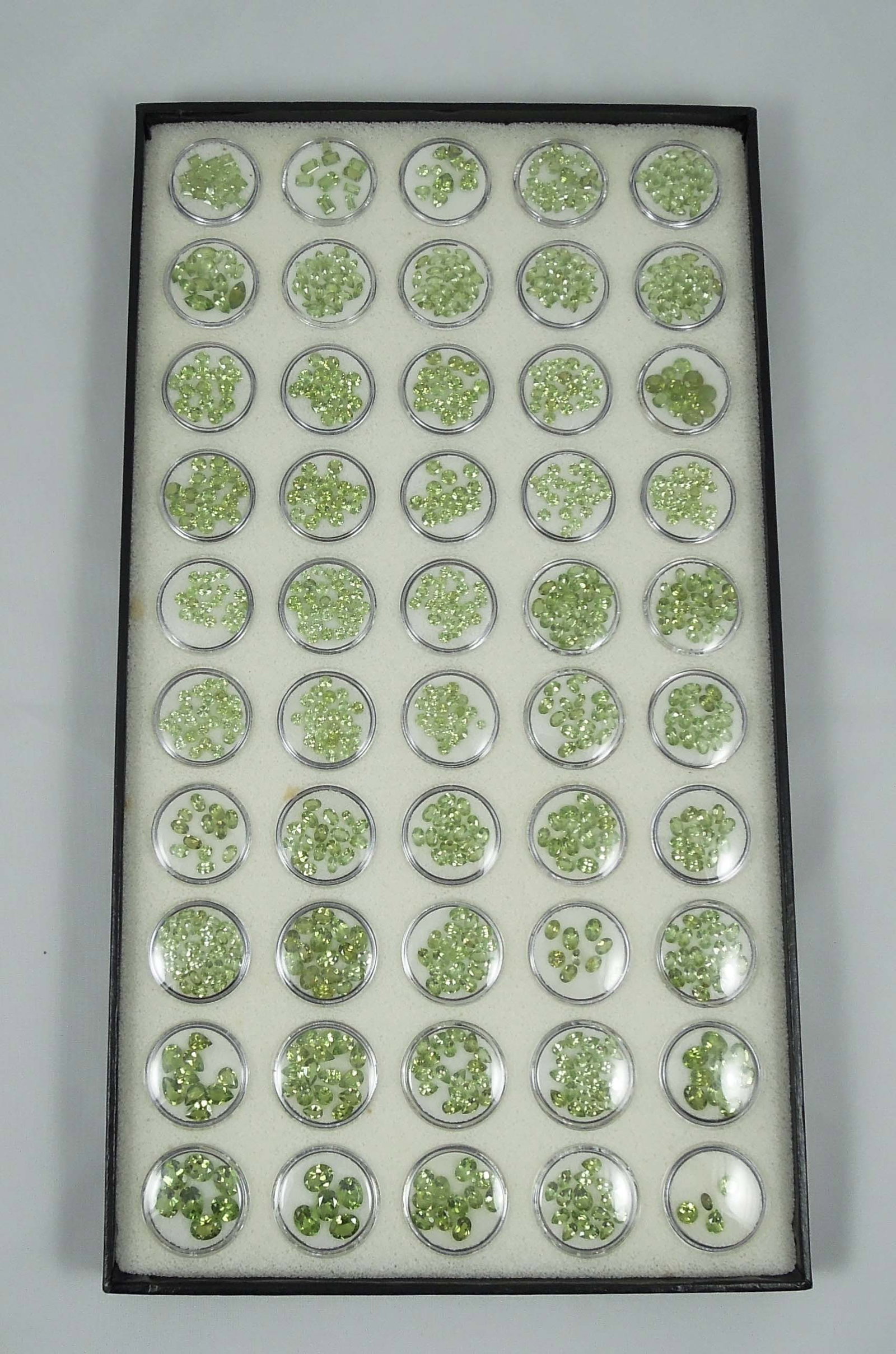 100'S CTS. OF FACETED PERIDOT: Cased box.