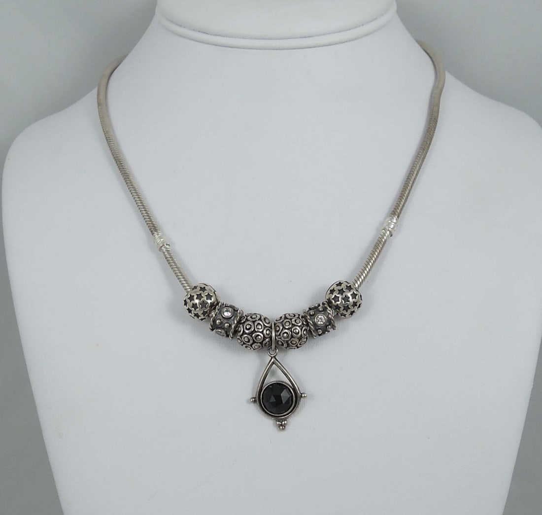RARE AUTHENTIC PANDORA STERLING SILVER CHARM & PENDANT NECKLACE: Six sliding charms and a rare retired Pandora faceted black spinel medallion pendant. Excellent condition.