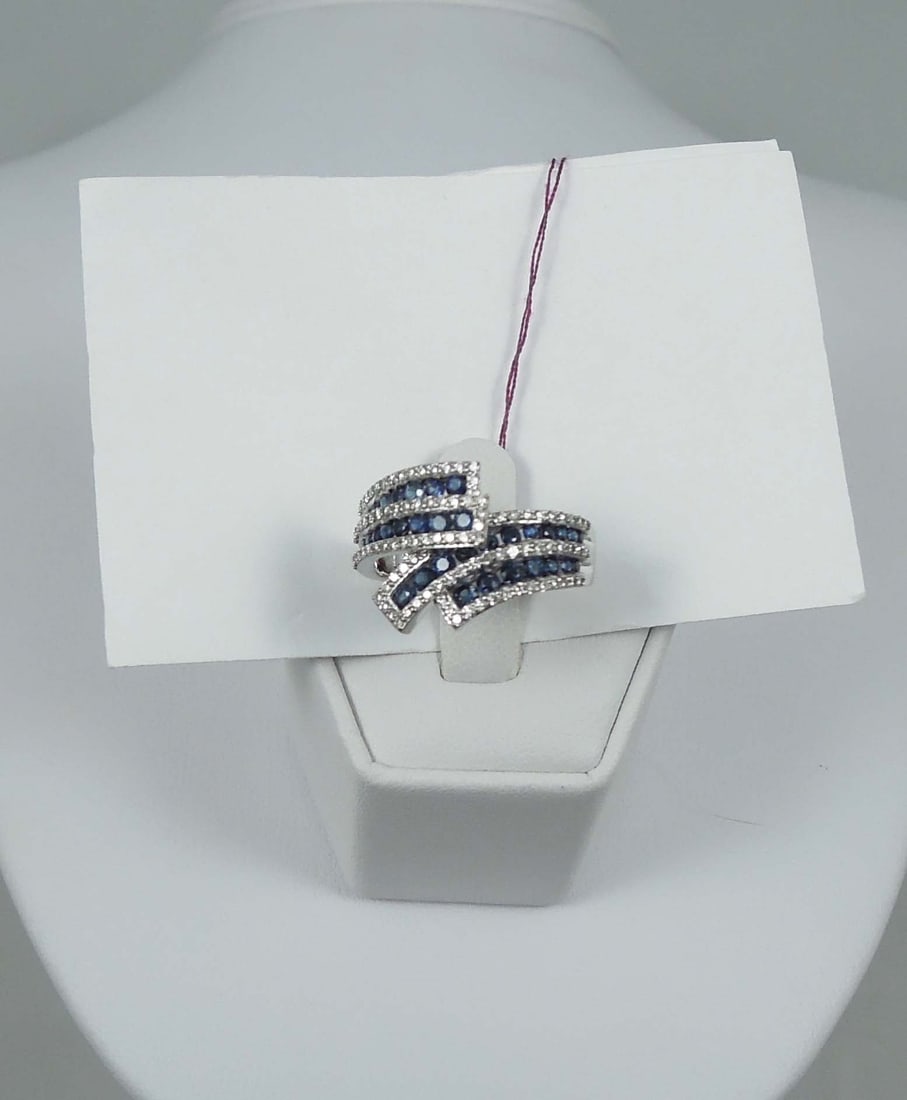 LADIES 10K W.G., SAPPHHIRE & DIAMOND RING: A white gold mount set with four rows of round sapphires totaling approx. .75 ct. Each row of sapphires surrounded by a single row of full cut round dialmonds totaling approx. .40 ct.