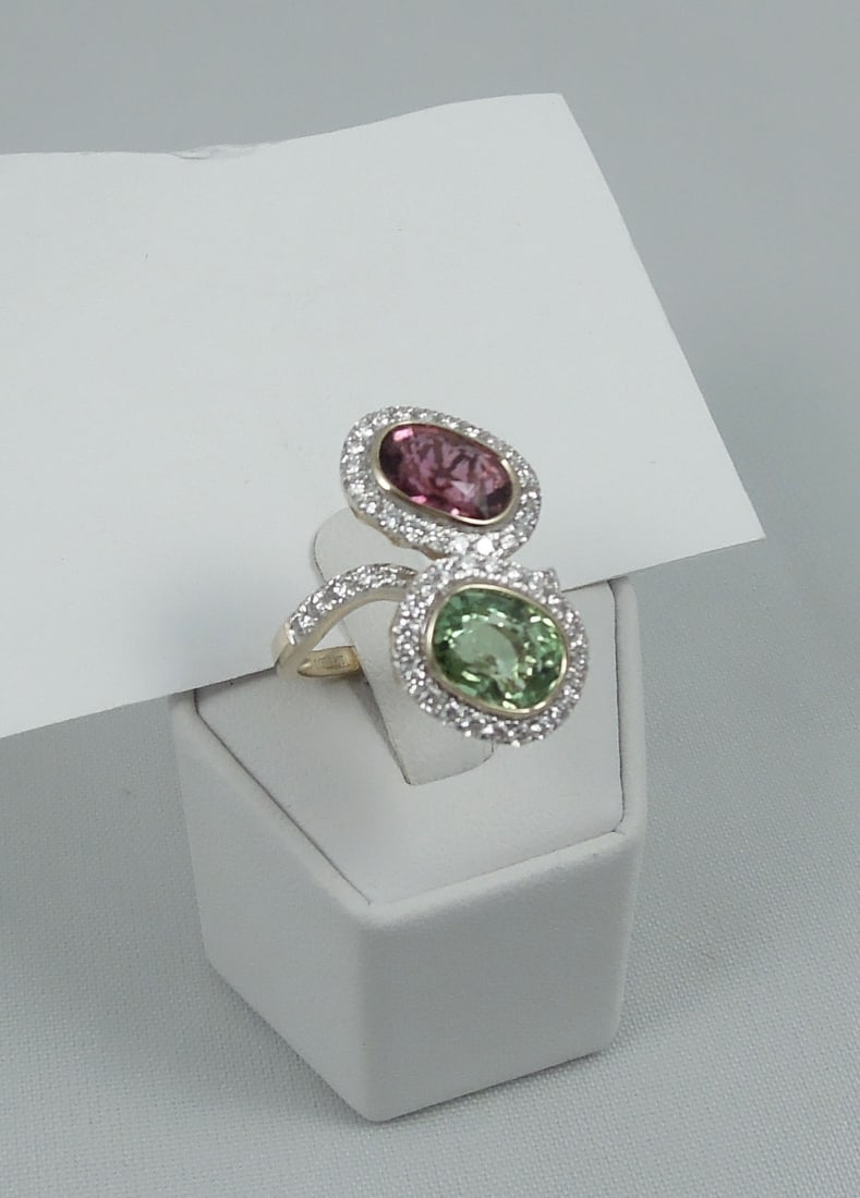 LADIES 14K Y.G., RUBELITE, TOURMALINE & DIAMOND RING: An unusual 14k gold ring set with a very fine rubelite and greenish/yellow tourmaline. Each stone surrounded by a single row of full cut round diiamonds. Total weight of rubelite and tourmaline approx