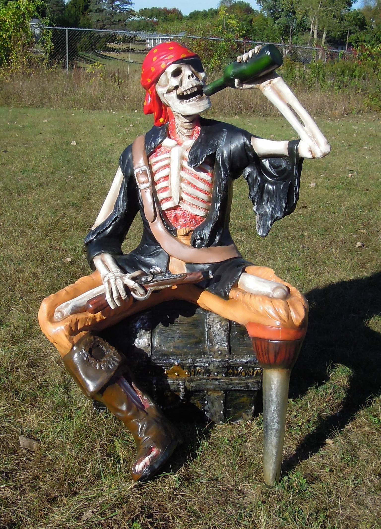 LARGE LIFE SIZE HAND PAINTED RESIN SCULPTURE OF PEG LEG SKELETON SEATED ON TREASURE CHEST: Excellent condition. 51" high, 37" wide, 35" deep.