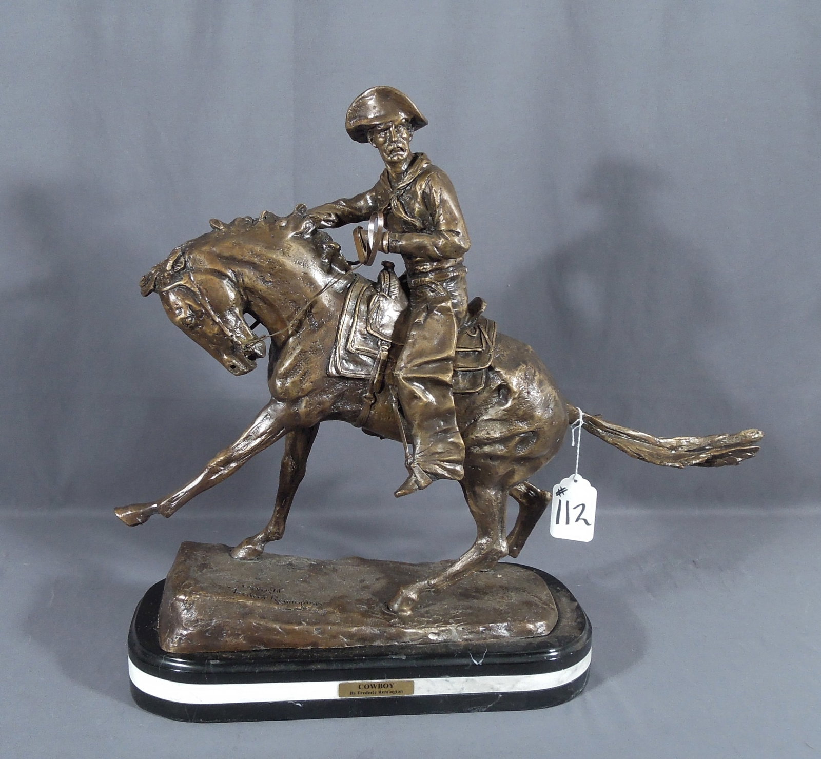 LARGE BRONZE SCULPTURE "THE COWBOY" AFTER FREDERIC REMINGTON: Signed. Triple marble base. 23" high, 25" wide, 7 1/2" deep.
