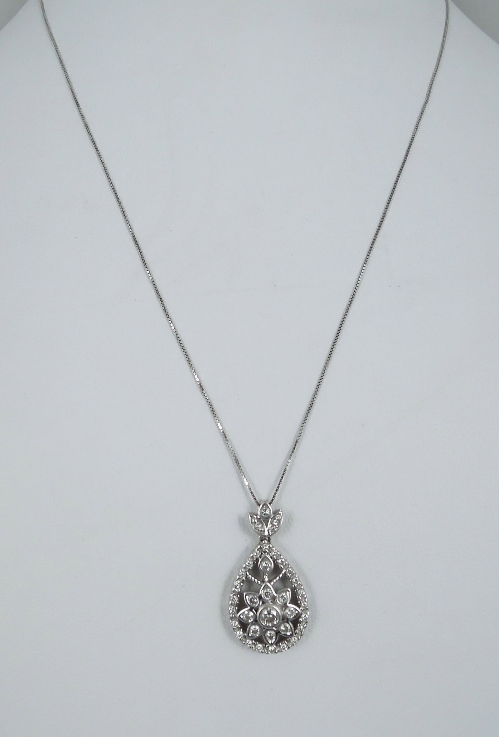 LADIES 10K & 14K W.G. AND DIAMOND NECKLACE: A 10k white gold supports a 14k white gold tear drop pendant set with full cut round diamonds totaling approx. .50 ct.