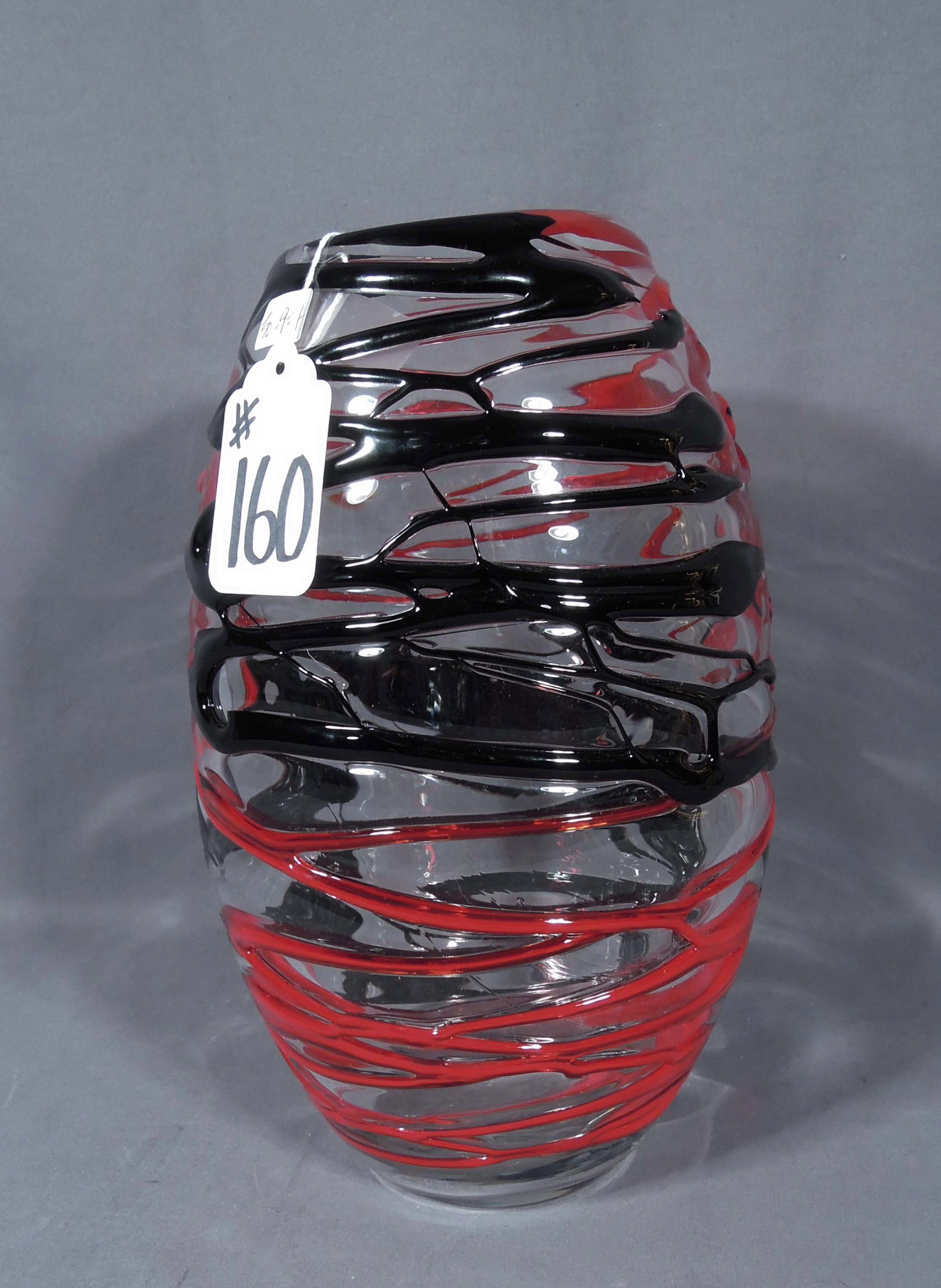 HAND BLOWN ART GLASS VASE WITH ABSTRACT PATTERN: Red and black glass trails. 12 1/2" high, 7 1/2" dia.