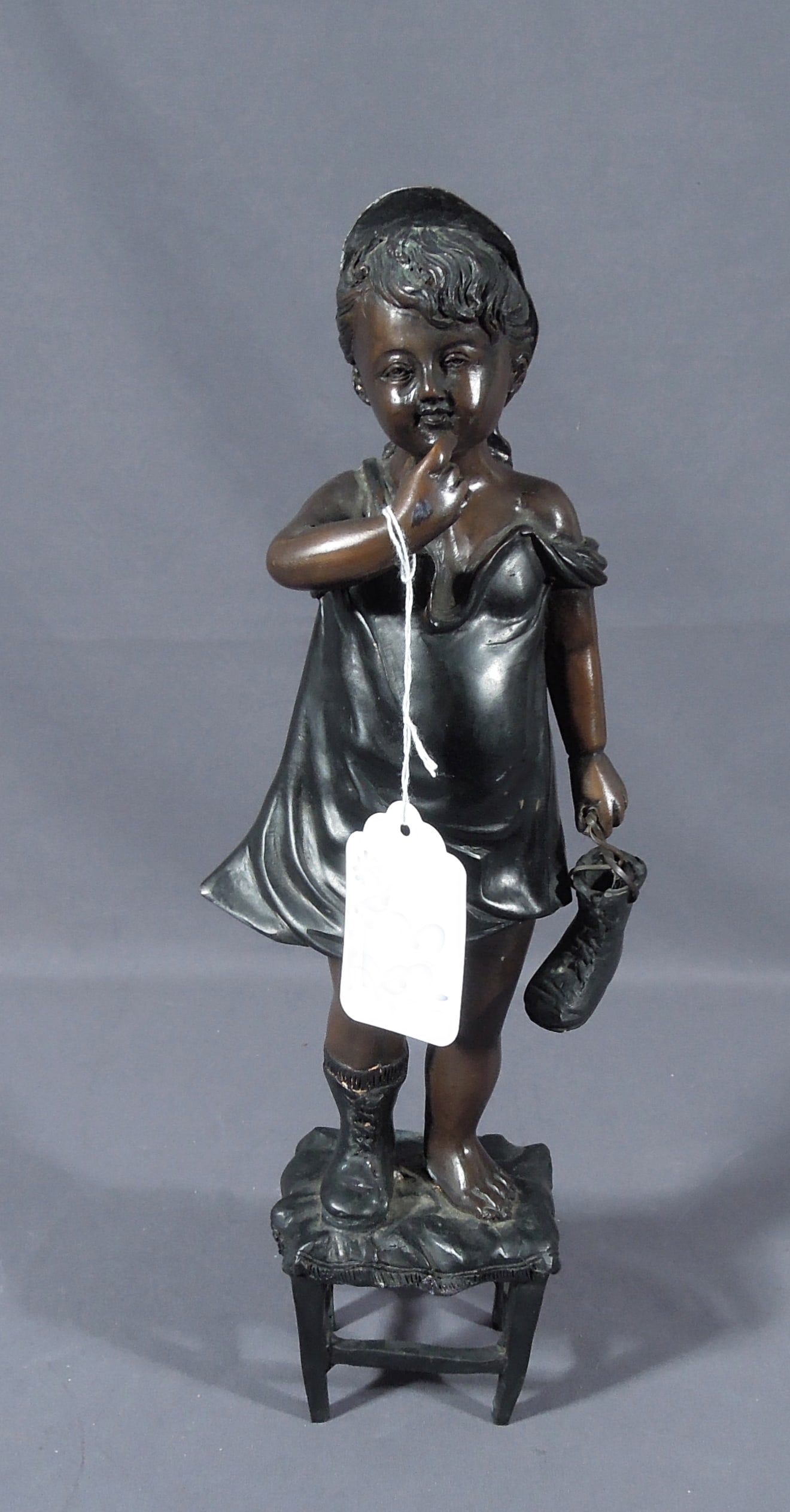 VINTAGE BRONZE SCULPTURE OF YOUNG GIRL STANDING ON STOOL: Aged brown patina. 15 1/2" high.