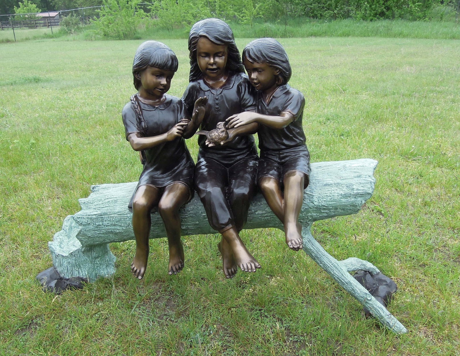 Three children seated on log petting a bird. Fabulous detail. Three color patina. Excellent condi: Three children seated on log petting a bird. Fabulous detail. Three color patina. Excellent condition. 38" high, 51" wide, 19" deep.